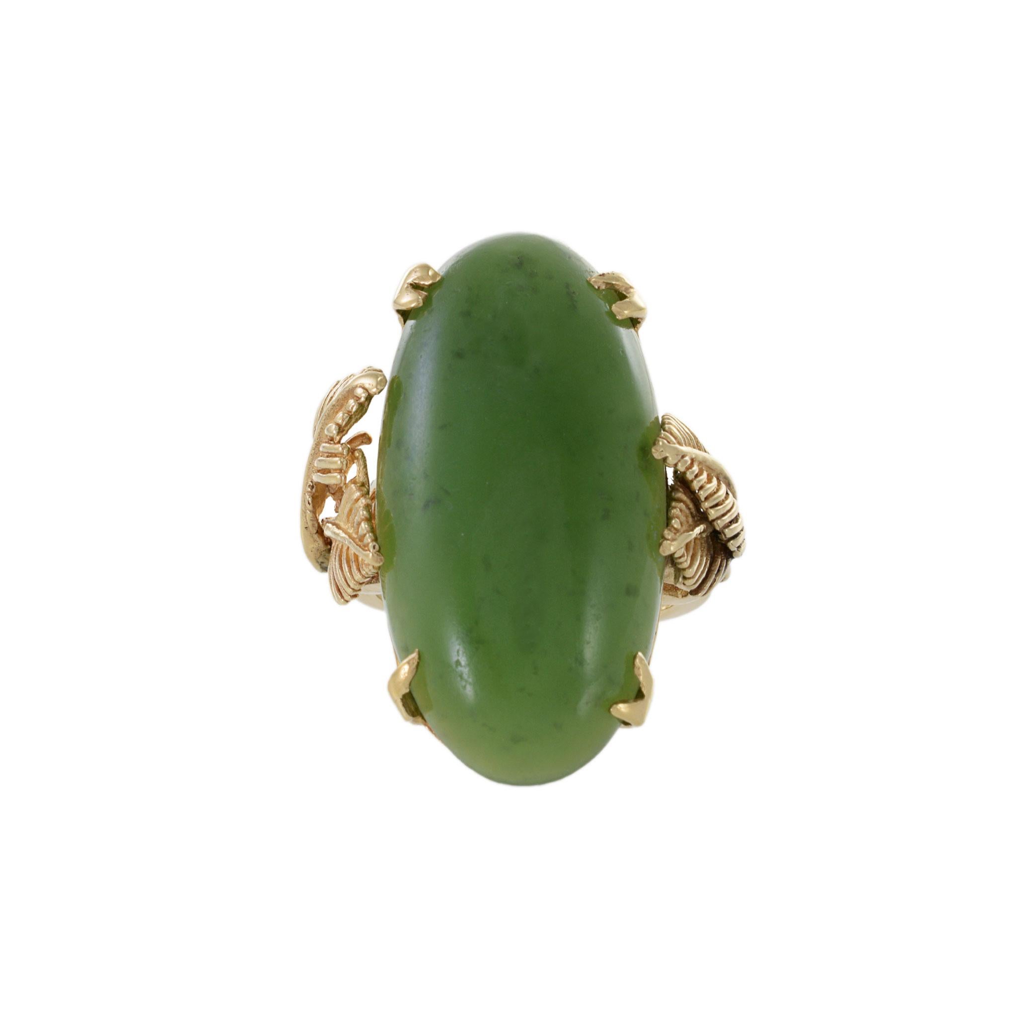 This estate Retro era ring features a striking genuine oval jade stone set in warm 18KT yellow gold. The jade stone has a rich, deep green color with a beautiful translucency that catches the light in a unique and captivating way. The ring's gold