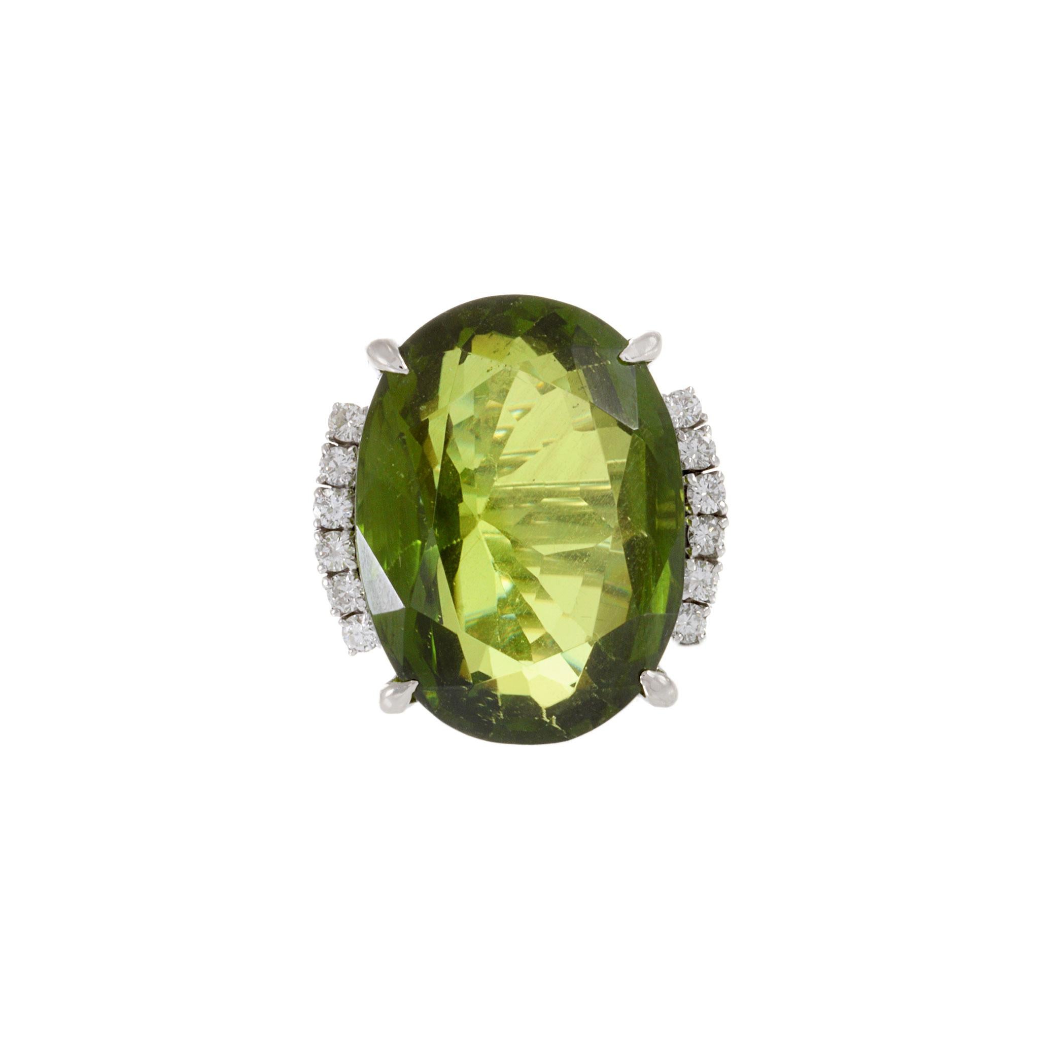 Explore vintage glamour with our Estate Retro Era Platinum Peridot and Diamond Ring. This exquisite piece features one natural oval-cut peridot weighing 38.50ct, surrounded by 0.43ct-tw F-VS round-cut diamonds. Crafted in platinum, this ring