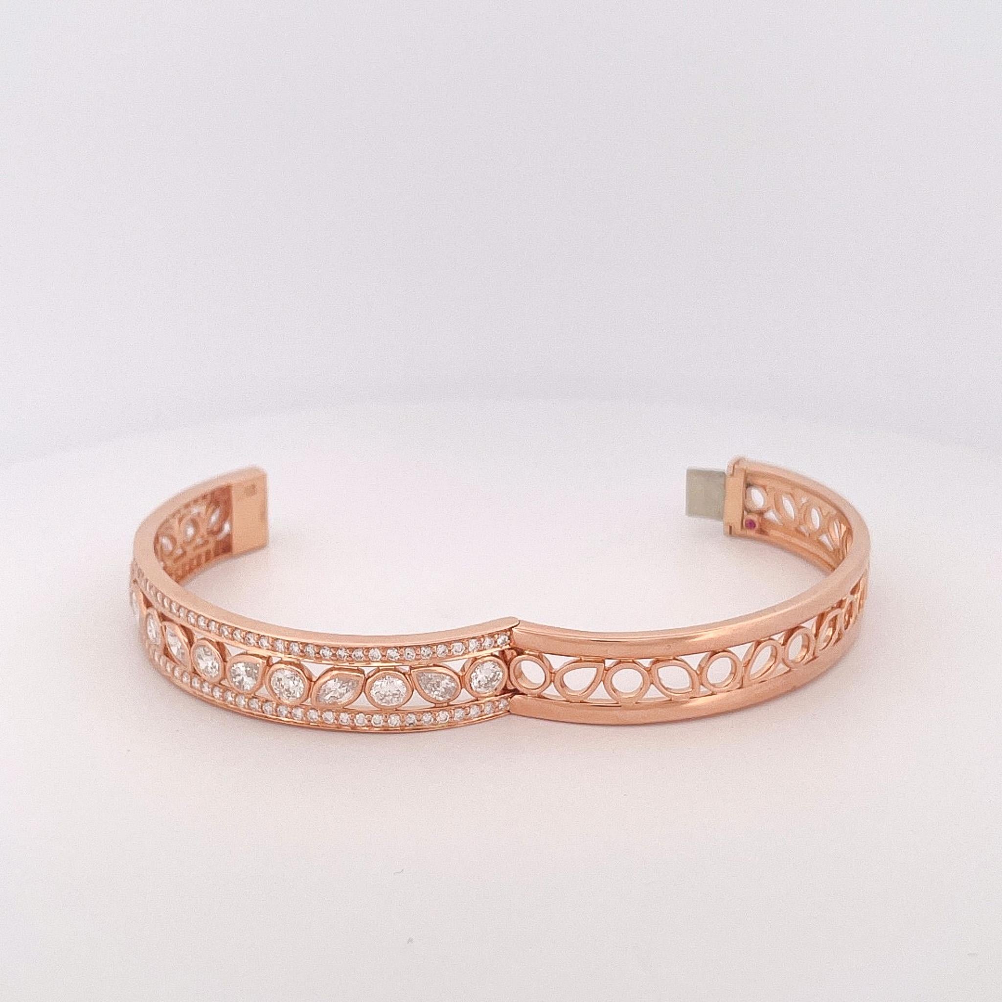 From designer Roberto Coin’s Cento Dolce Collection, 18 karat rose gold diamond bangle. This bangle is crafted with an assortment of a round brilliant cut, marquise shape, pear shape, and round cut diamonds with a total combined weight of 6.00