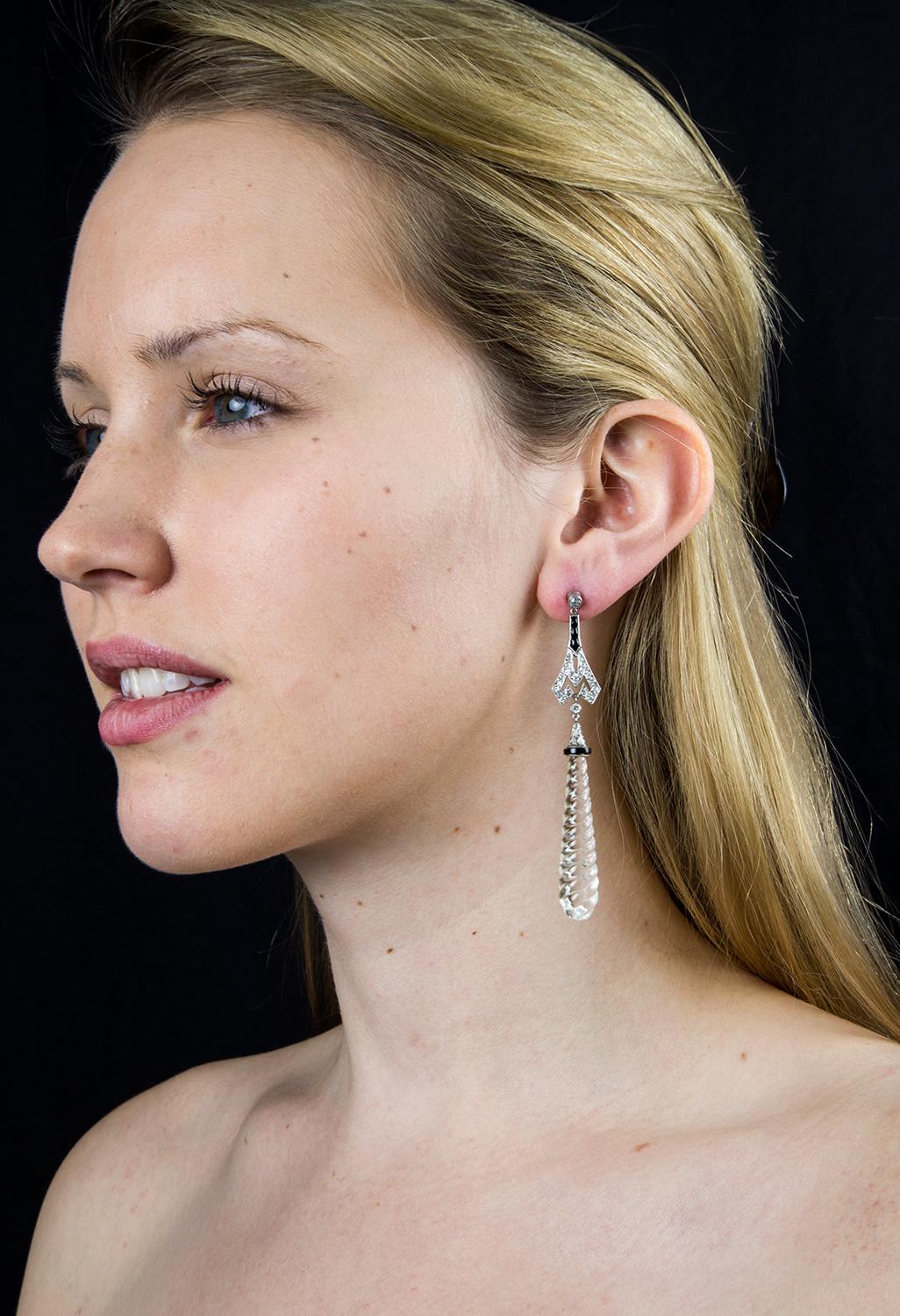 Stylish and Classic Dangle Earrings; each earring features a large tear-drop shaped rock crystal, suspended from the Diamond and Onyx topper; hand crafted with  platinum mounts; approx. 1 Carat total diamond weight. These bold, yet understated
