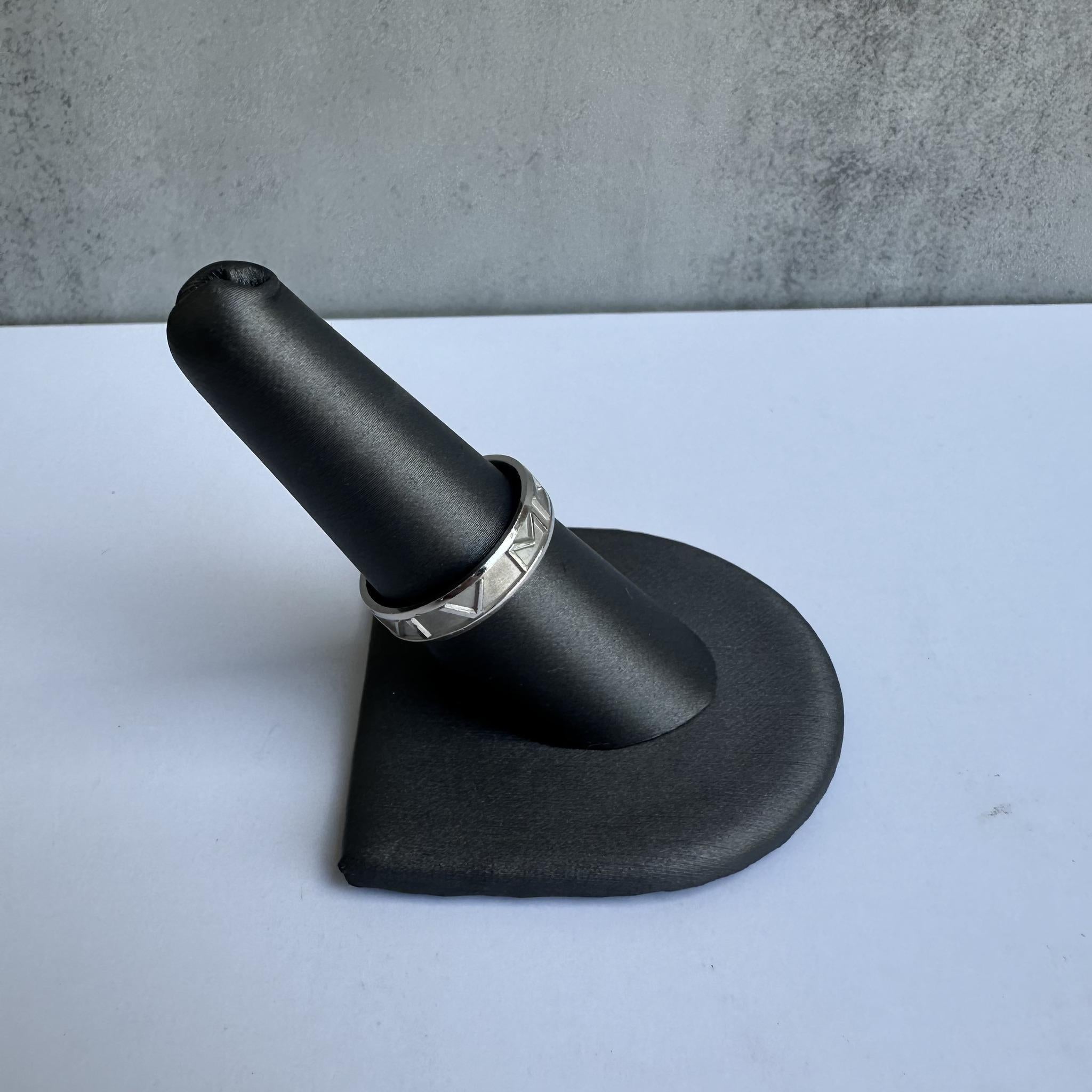 Experience timeless elegance with this Roman Numeral Platinum Ring by John Christian. Crafted from luxurious platinum and weighing 8.11 grams, this ring features a classic Roman numeral design that encircles the band, offering a sophisticated and