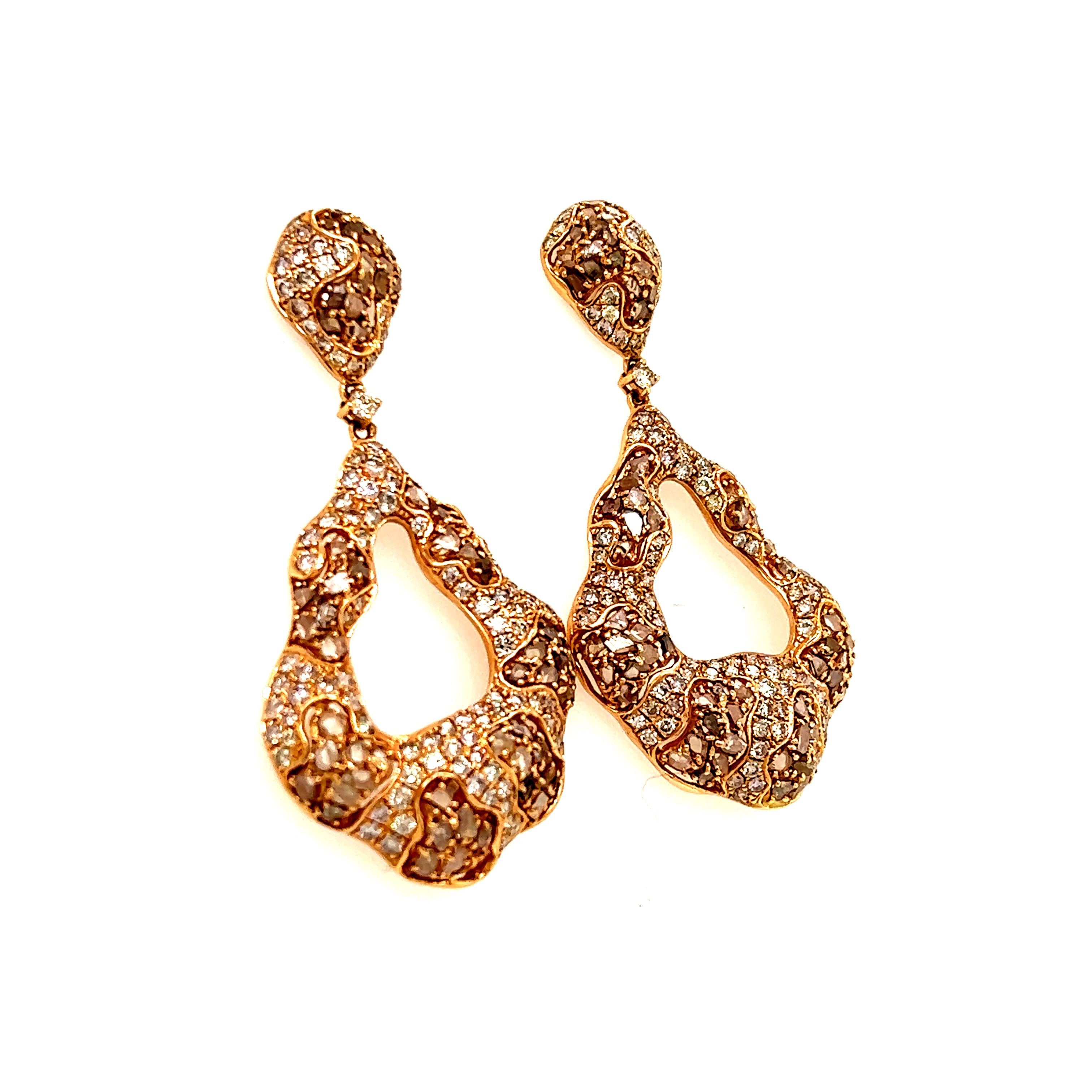 Beautiful pair of door knocker earrings crafted in 18k rose gold. The pair show a stud backing that leads to a dangling hoop portion with a unique vintage appeal. The earrings are set with round brilliant cut diamond accents, however the highlight