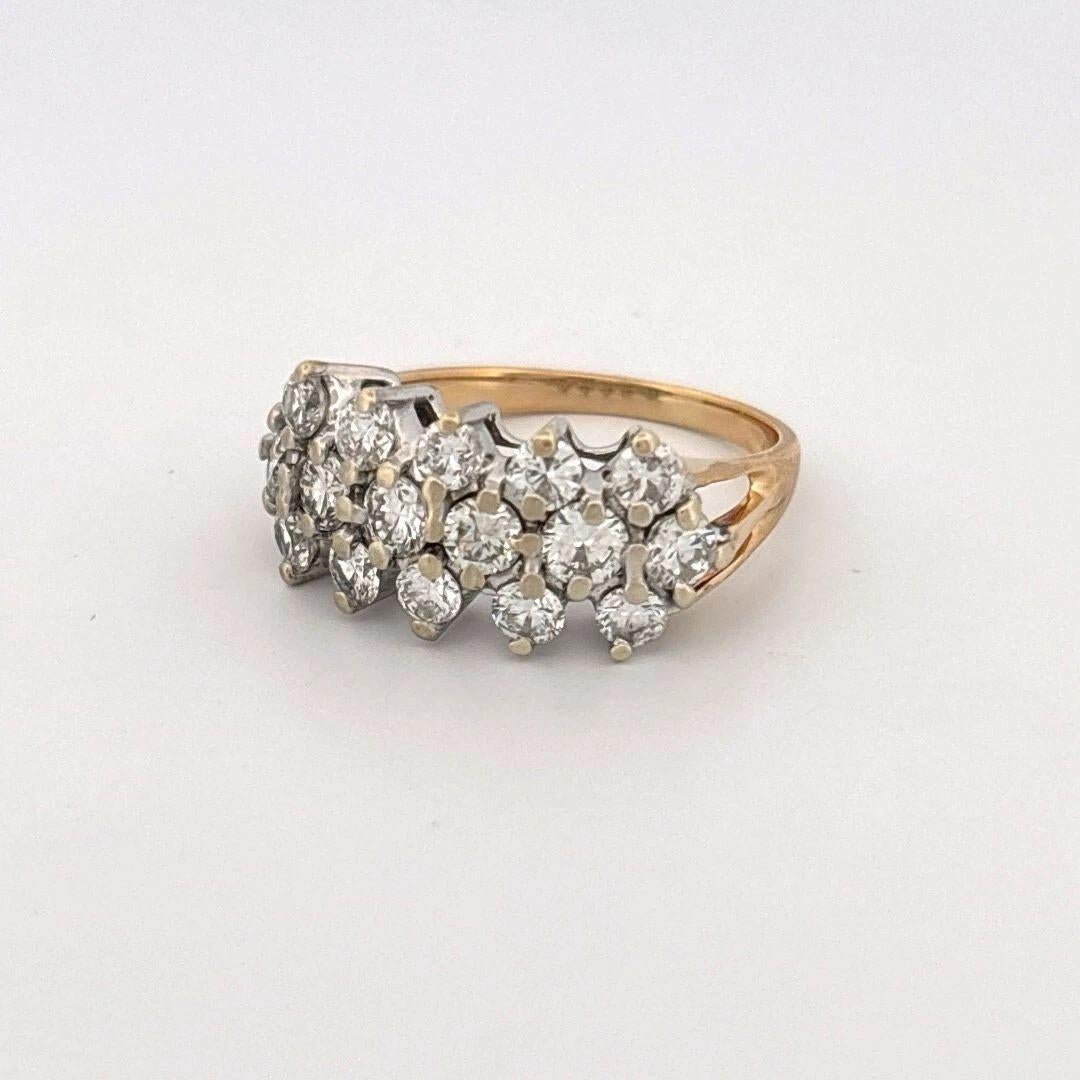 This stunning estate ring features sixteen (16) natural round brilliant cut diamonds, each weighing approximately 0.10 carats, for an estimated total weight of 1.60 carats. The diamonds are eye-clean SI clarity and near-colorless H-I color, with