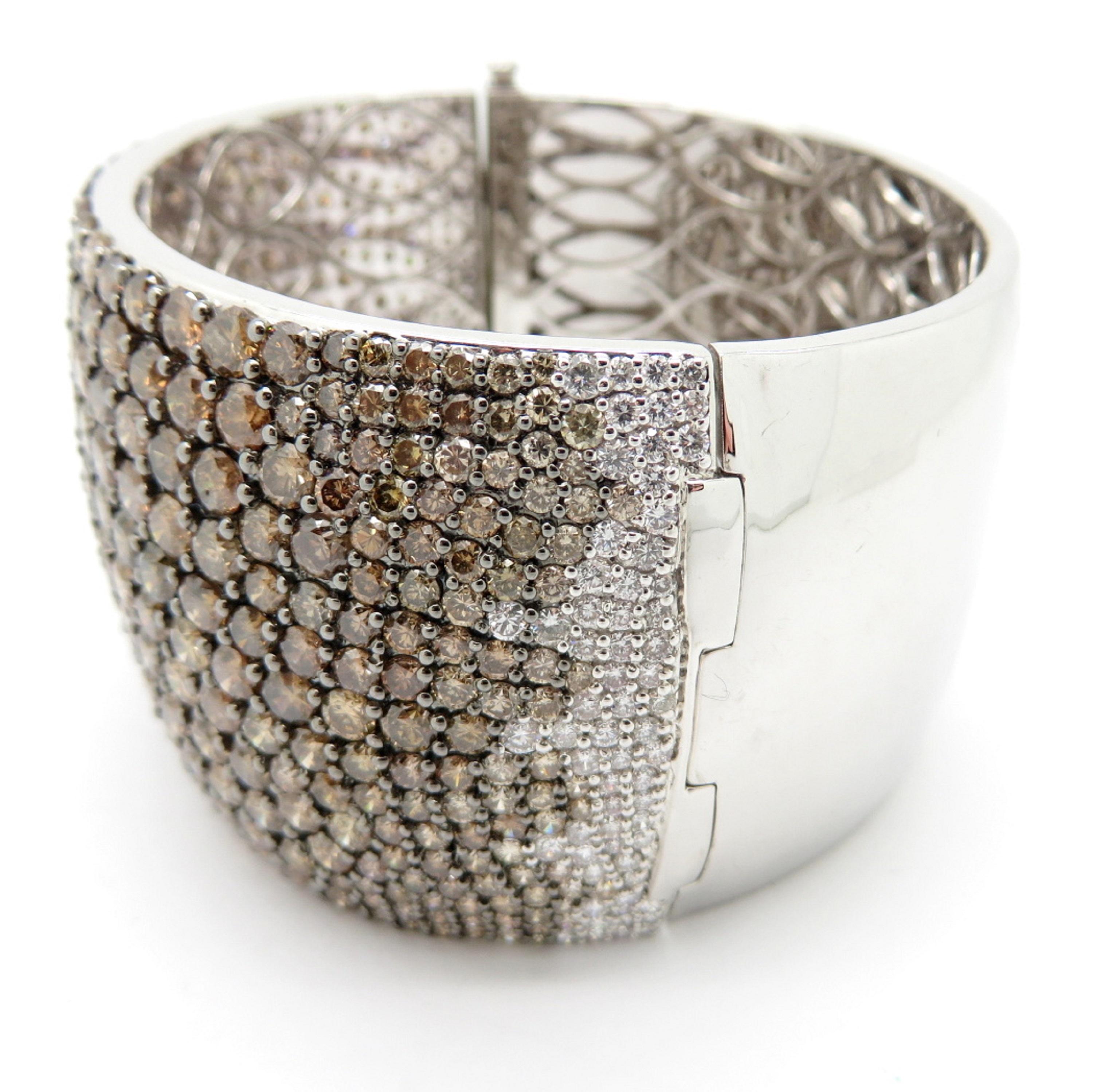 For sale is a stunning 18K White Gold Brown & White Diamond Pave Bangle Bracelet!
Showcasing 462 Brown Round Brilliant Cut diamonds, pave set, weighing approximately 50.41 carats, having SI1-I2 Clarity Grade.
Interspersed through the bracelet are 68