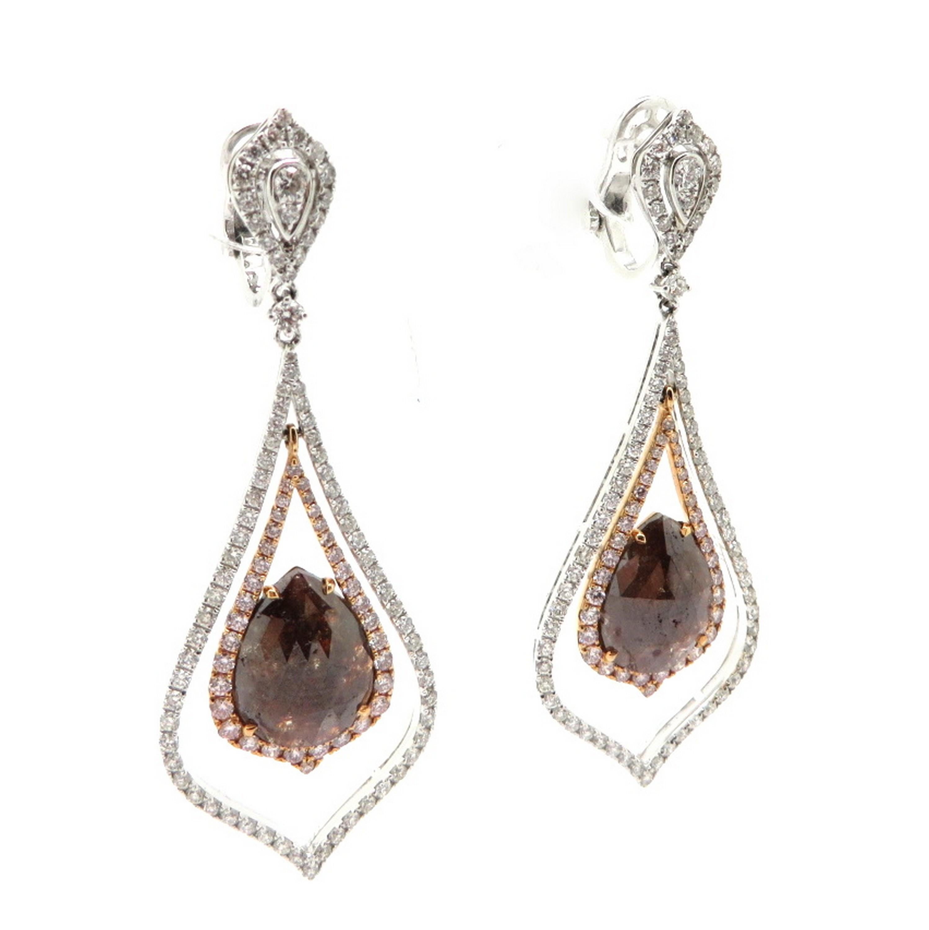 Estate round white and pink diamond dangle drop earrings set in 18K two-tone gold. Showcasing two pear shaped brown diamonds, weighing 9.17 carats. Accented with 72 fancy pink round brilliant cut diamonds, weighing 0.90 carats total and 156 round