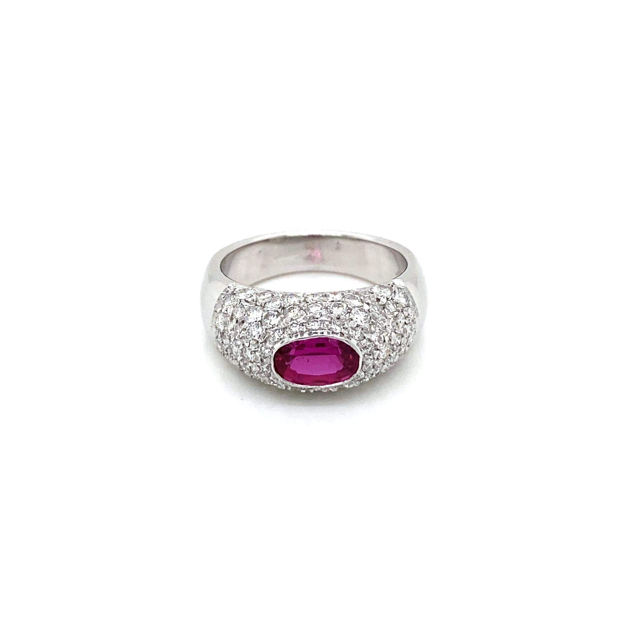 A timeless design Diamond band ring set in 18k white gold, it features a vivid natural oval Ruby in the center, weight 1.10 carat, surrounded by 1.50 carats of Sparkling Round brilliant cut diamond, graded G Color VS clarity, pavé setting. When