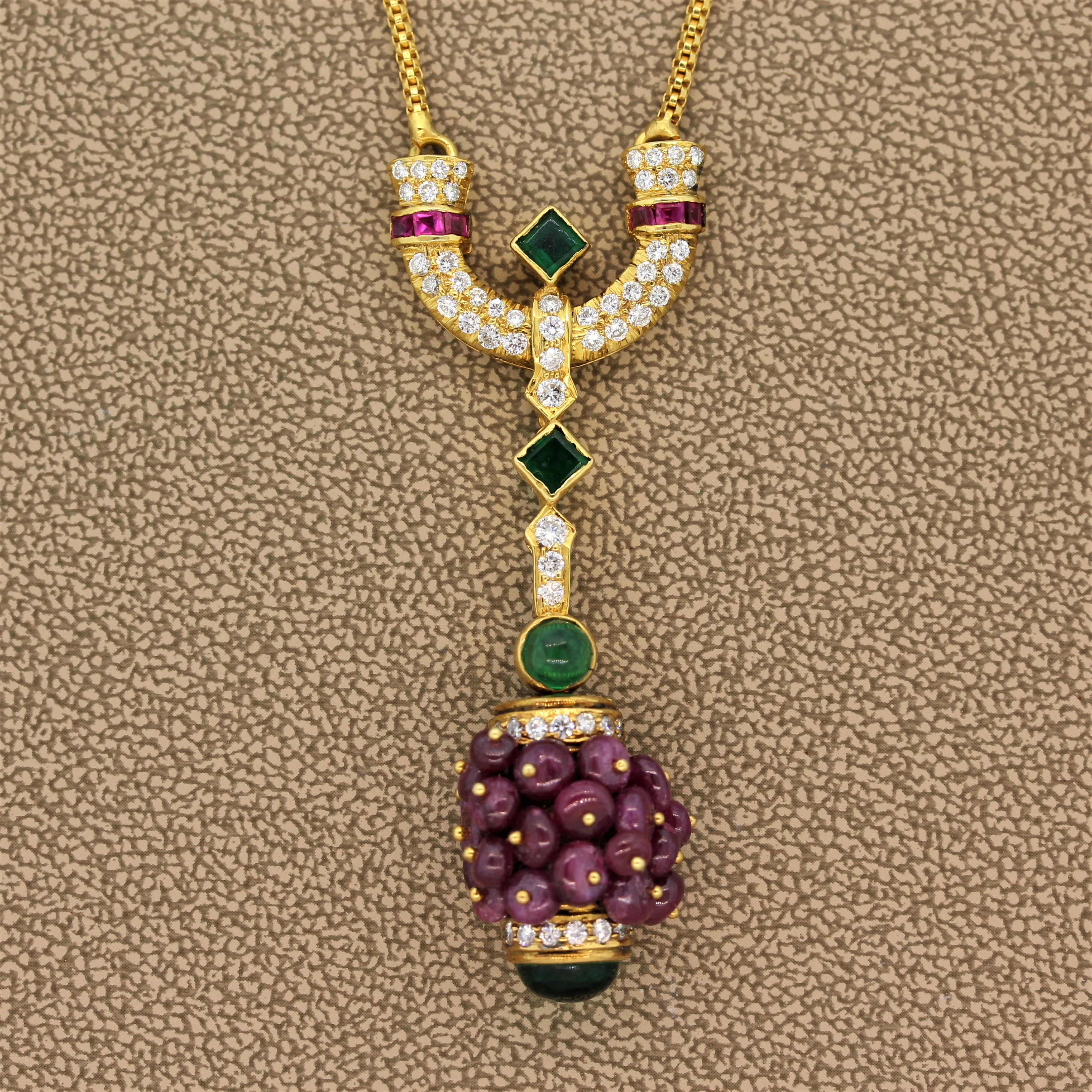 This estate drop necklace features approximately 15.00 carats of beaded ruby  and cabochon emeralds in a bezel setting. They are accented by 0.90 carats of round cut diamonds in a 22K yellow gold hand made setting. A true one of a kind