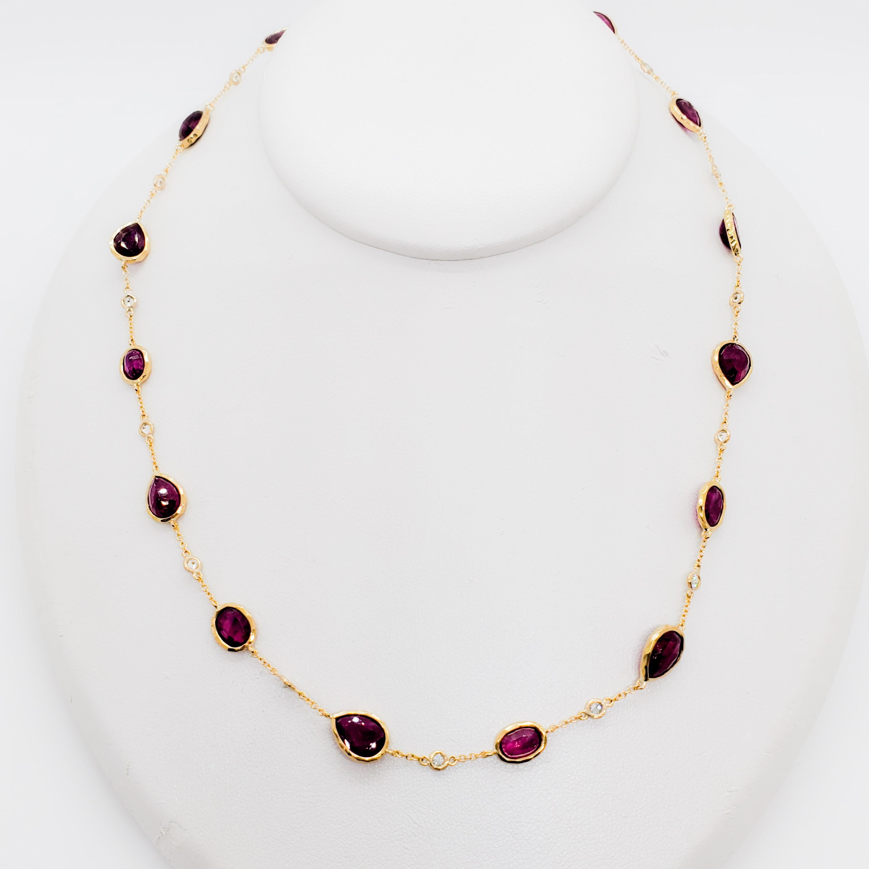Stunning necklace showcasing 14 ruby multishape stones and several diamond rounds.  All gemstones and diamonds are very good quality with depth of color and brightness.  Length of necklace is 16