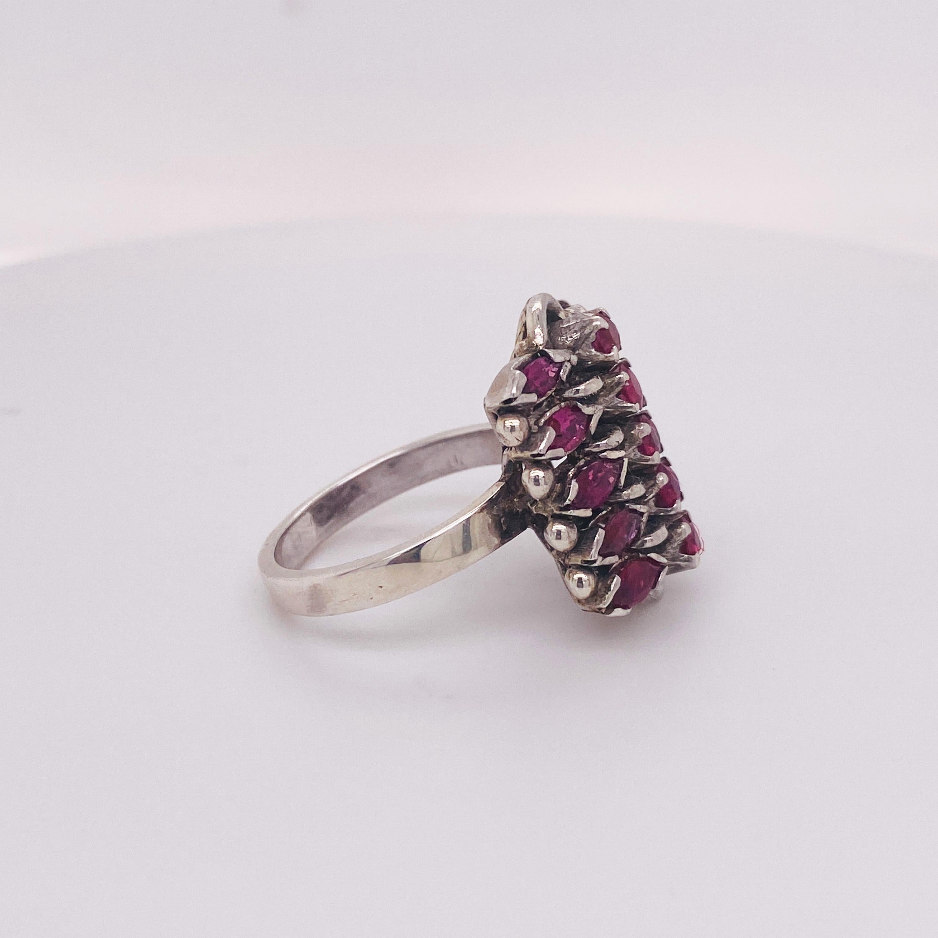 This genuine 1 carat ruby gemstone ring is vibrant in color and character! The design is a unique cluster made of bold ruby gemstones of different shapes - marquise and round. The bright ruby red is set in sterling silver. This is quite a special