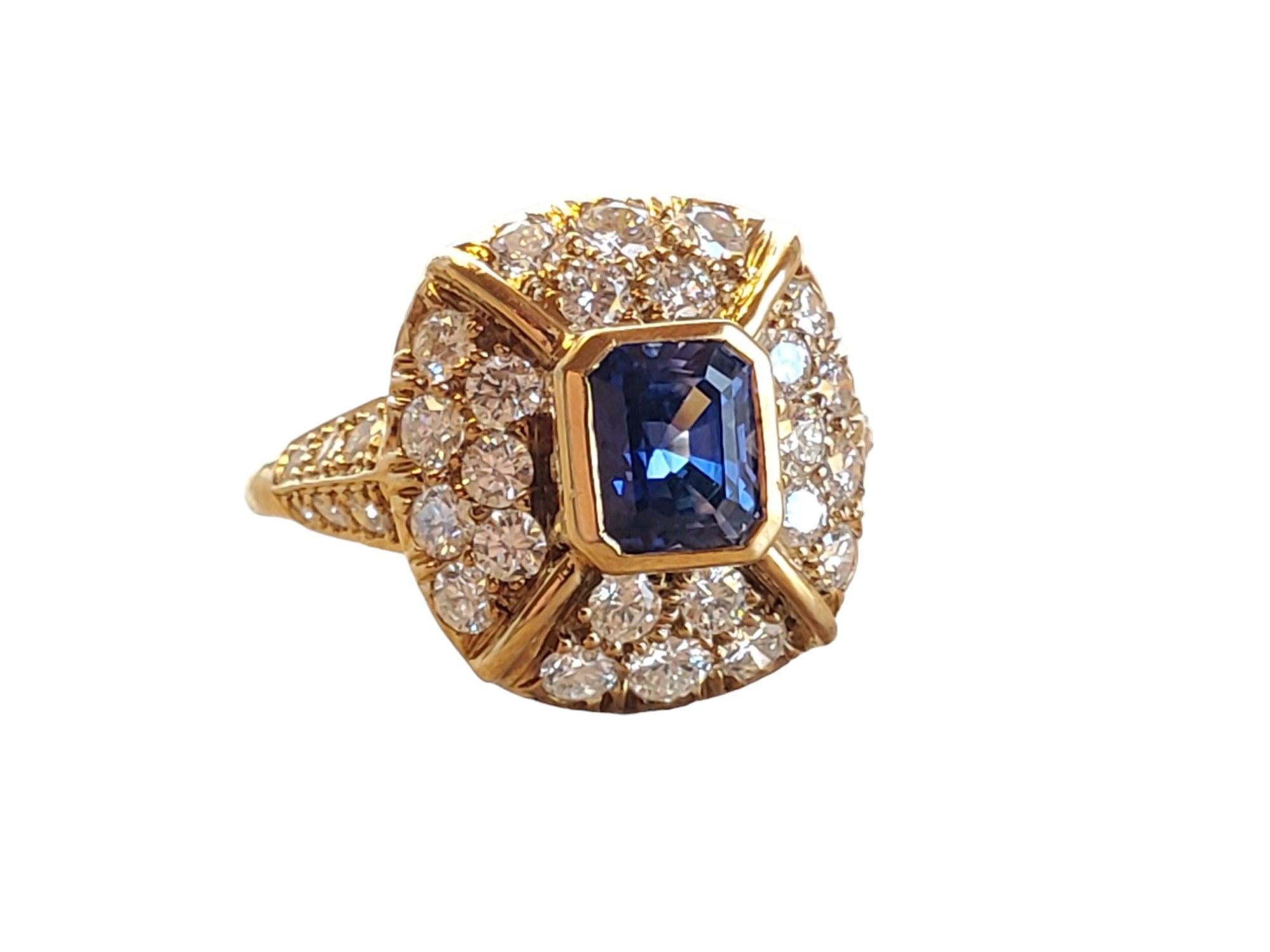 This listing is for an estate 18k yellow gold diamond and sapphire high end designer ring. It has approx. 1.50tcw white VS flush set round brilliant diamonds with a 1.10ct super clean and vibrant emerald cut blue sapphire center stone. The color is