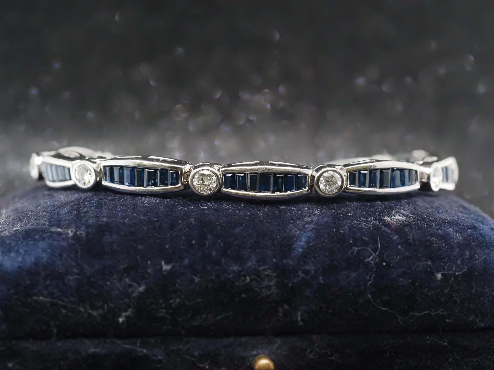 Year: 1980s

Item Details:
Metal Type: 14K White Gold [Hallmarked, and Tested]
Weight: 20.3 grams (All Items Total)

Stone Details: Natural, Sapphire, 6ct total weight, Blue, Baguette Step Cut.

Diamond Details: 2.00ct total weight, Round Brilliant,