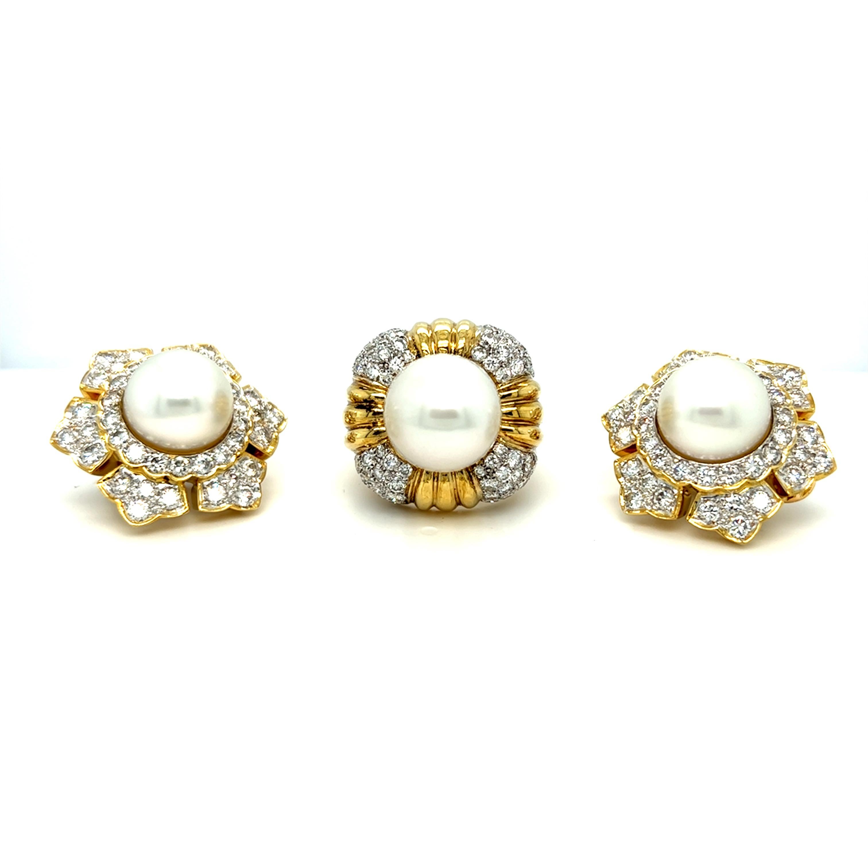 This fabulously elegant suite of estate ring and earrings are handcrafted in 18k yellow gold weighing 56 grams in total.  

These head-turner earrings each displays a stunning starburst of approximately 9 carat total diamond with a 12.6 mm beautiful
