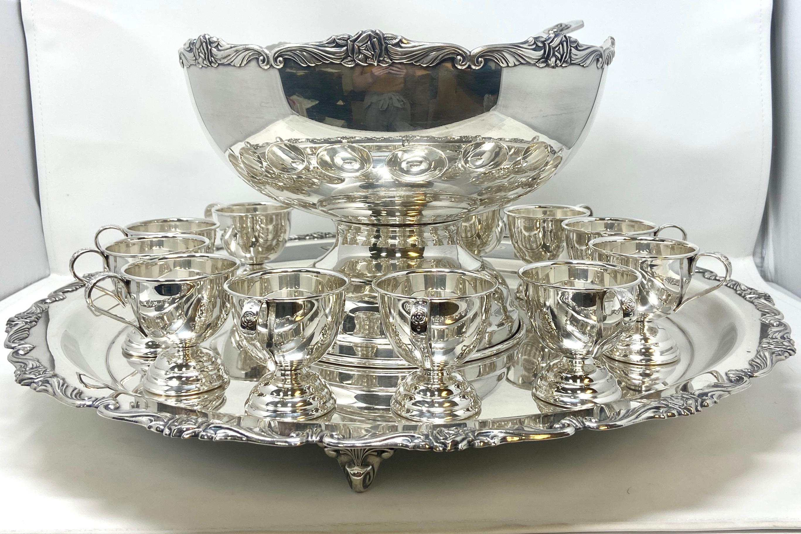 Estate silver-plated full punch bowl service with 12 footed cups, tray, and ladle, Circa 1950's. 
15 matching pieces in a classic Japanese Rose Design.
Overall: 11