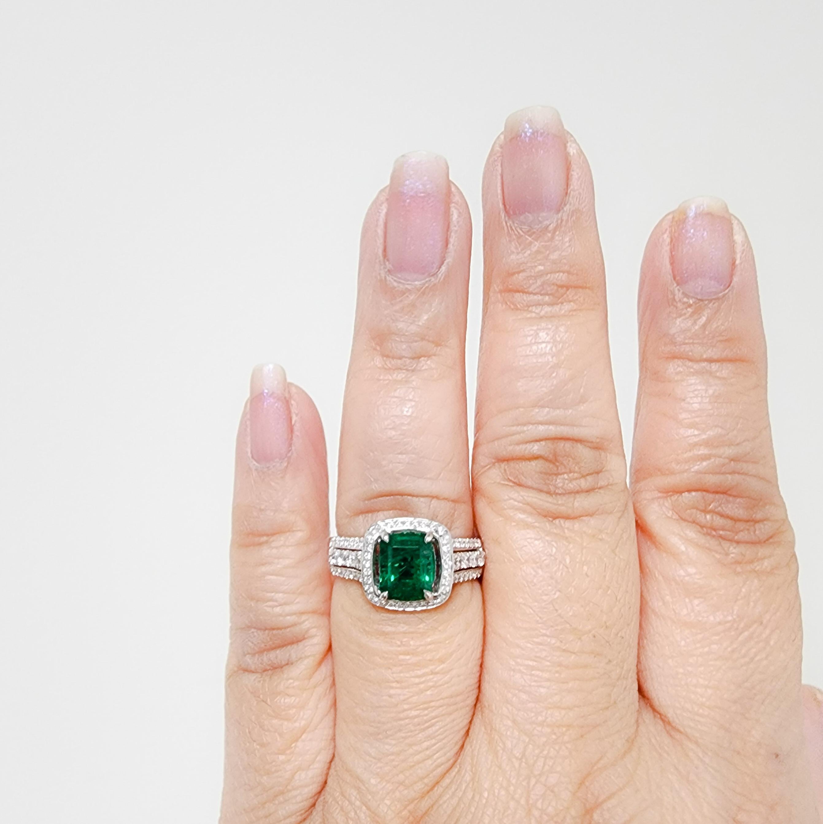 Beautiful 1.93 ct. emerald emerald cut with 0.60 ct. good quality white diamond rounds.  Handmade in 18k white gold by Simon G.  Ring size 8.