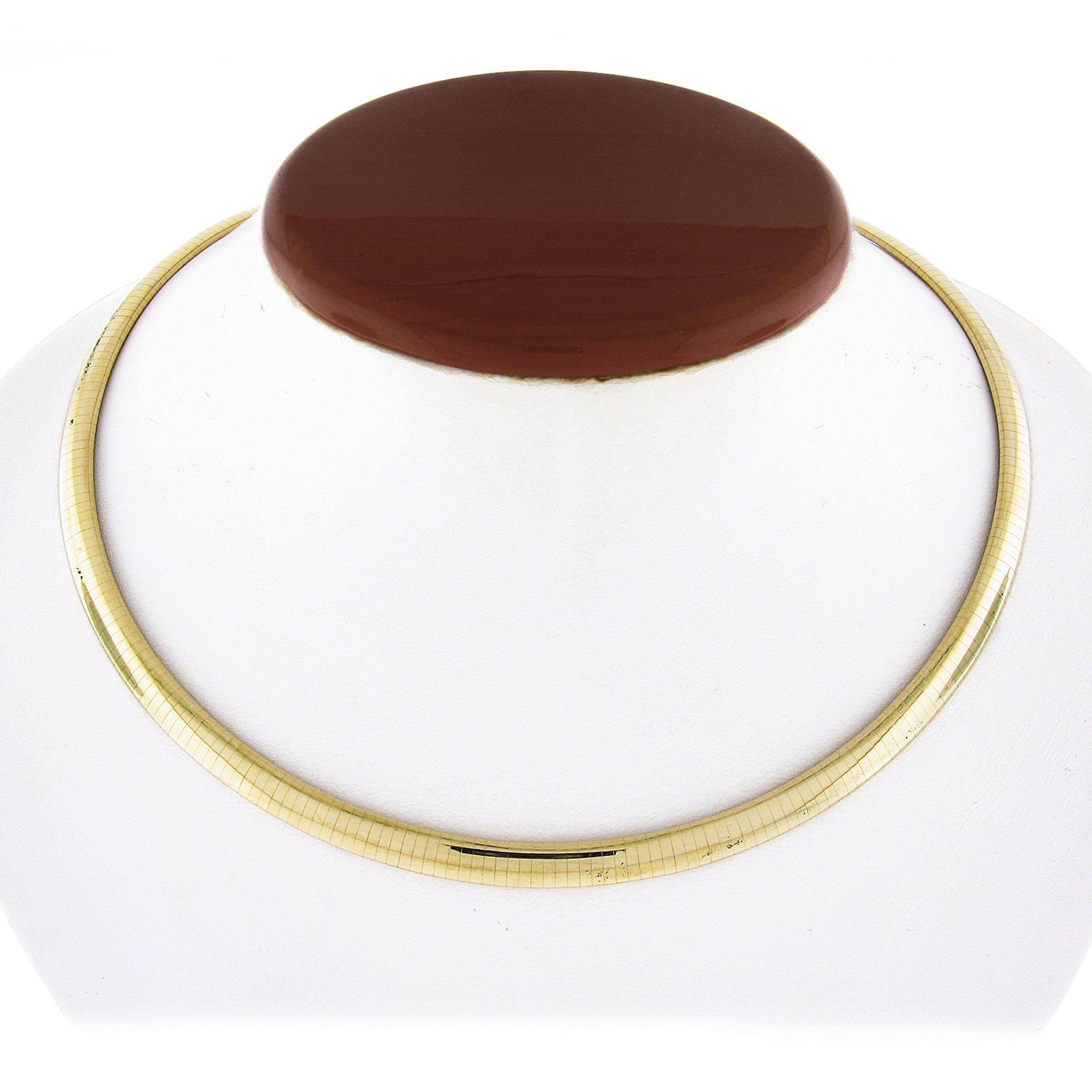 Here we have a fancy and very well made omega link collar choker necklace that was crafted from solid 14k yellow gold. This beautiful necklace measures 6mm wide and has a slightly domed surface with a wonderful high-polished finish throughout giving