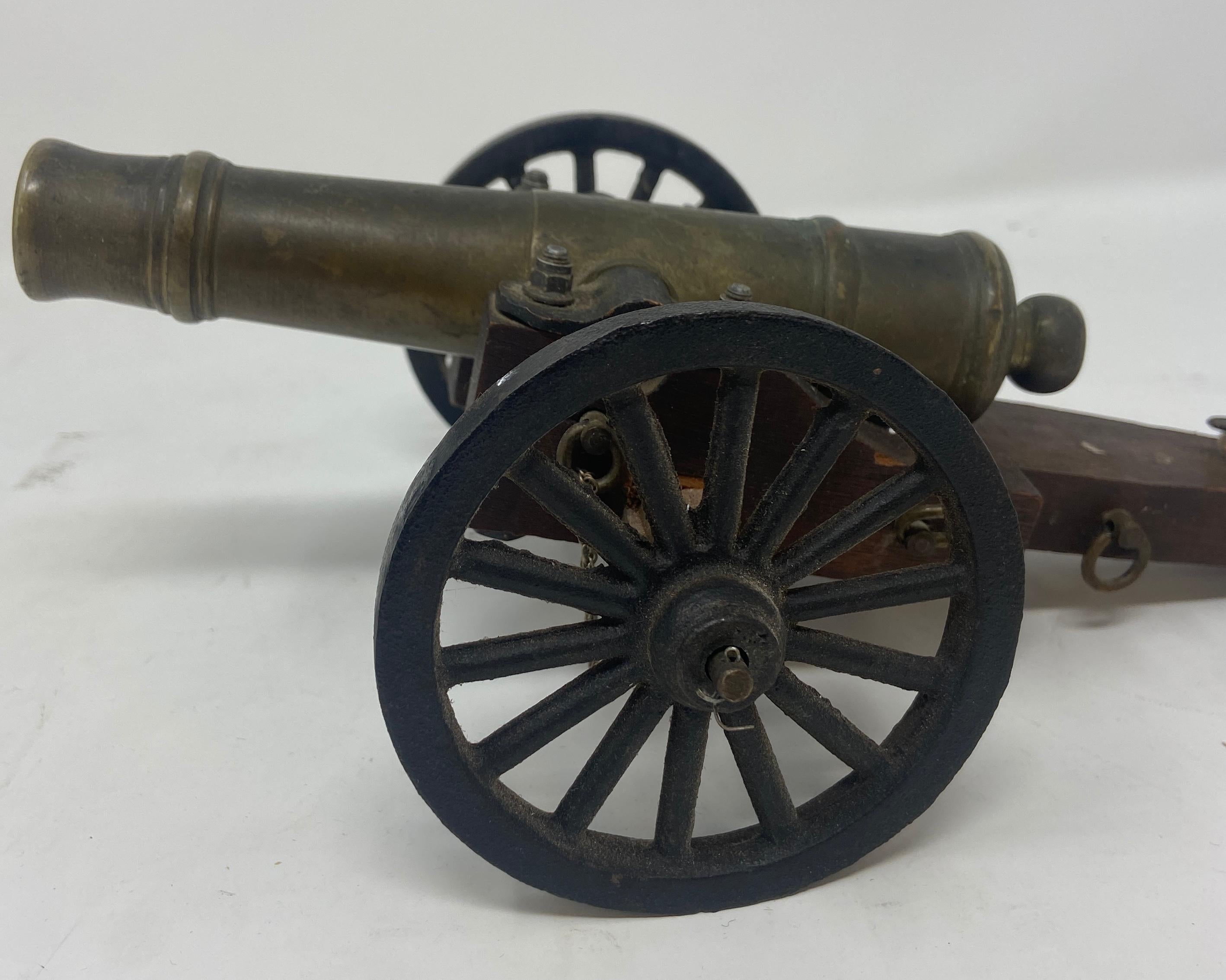 Estate Solid Bronze Top Miniature Model Military Cannon on a Wooden Carrier.
Cannon can roll an tilt up and down. Heavy, nice size miniature.
