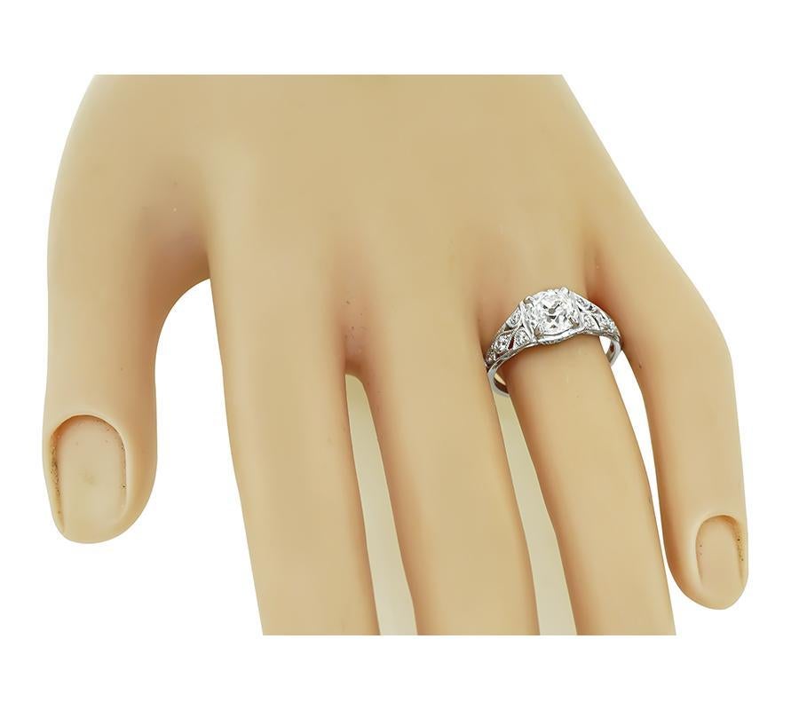This is an elegant platinum engagement ring by Sophia D. The ring is centered with sparkling GIA certified old mine cut diamond that weighs 1.33ct. The color of the diamond is F with VS1 clarity. The center diamond is accentuated by dazzling round