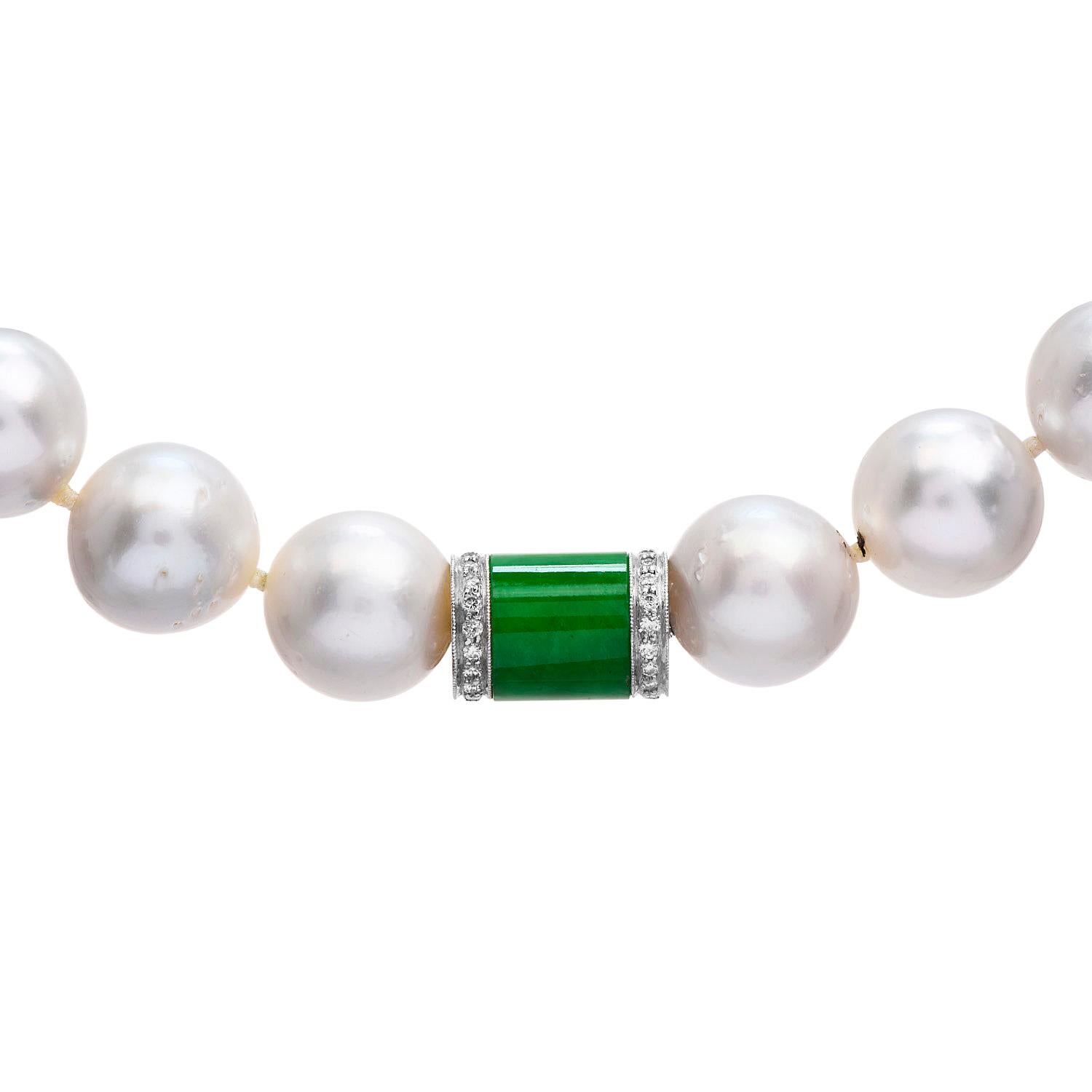 Ostentatious large looking white with silver undertones south sea pearls necklace, with a diamond and jade, accented clasp.

The clasp is crafted in solid 18K white gold, with (30) round cut, pave set diamonds, weighting collectively 0.30 carats,