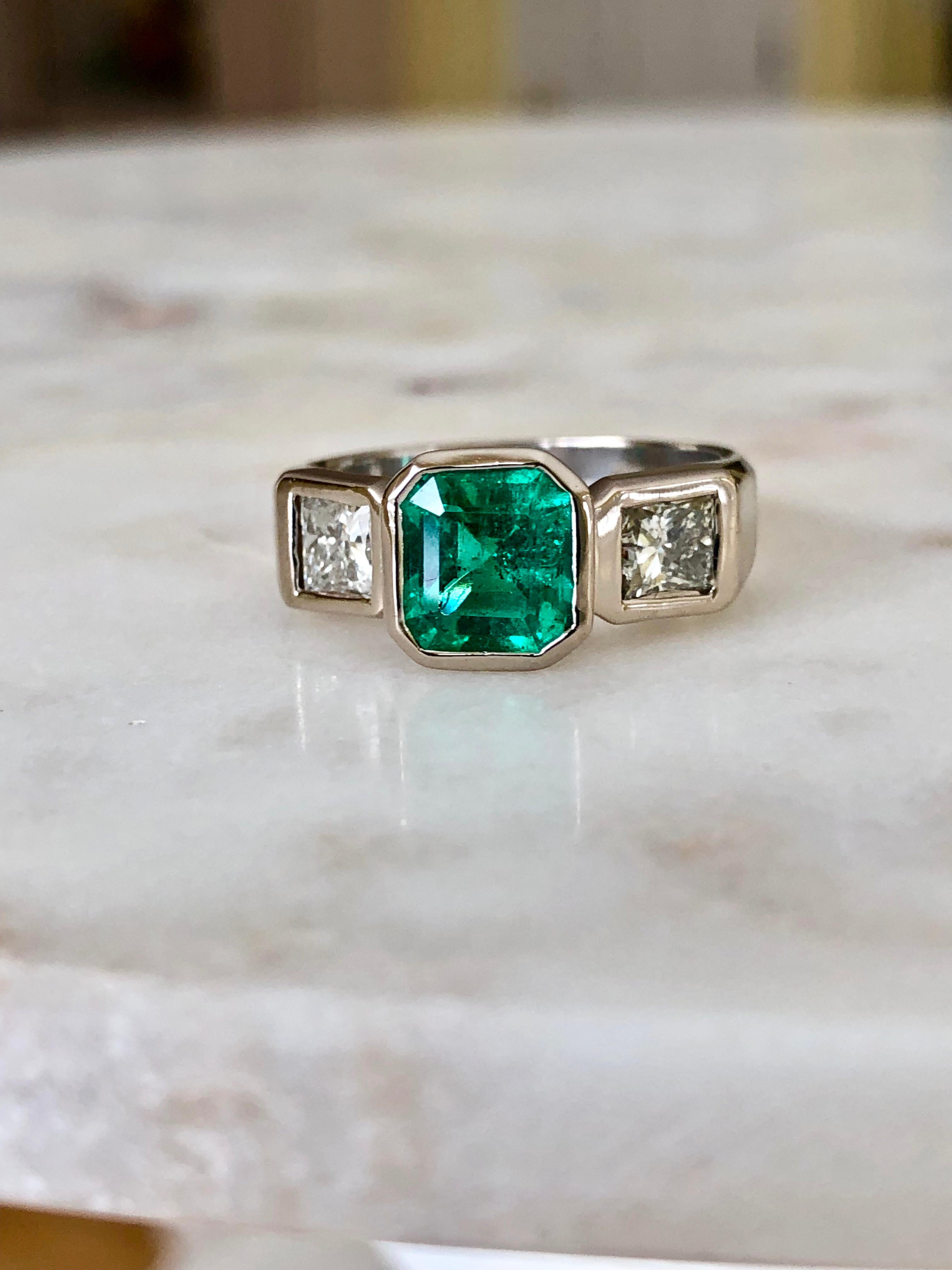 Natural Colombian emerald, diamond and 18K white gold ring, centering 1 bezel-set, emerald-cut, square emerald with bezel-set princess-cut  diamonds. Emerald is beautiful displaying excellent color and clarity.

100% Natural Colombian Emerald AAA