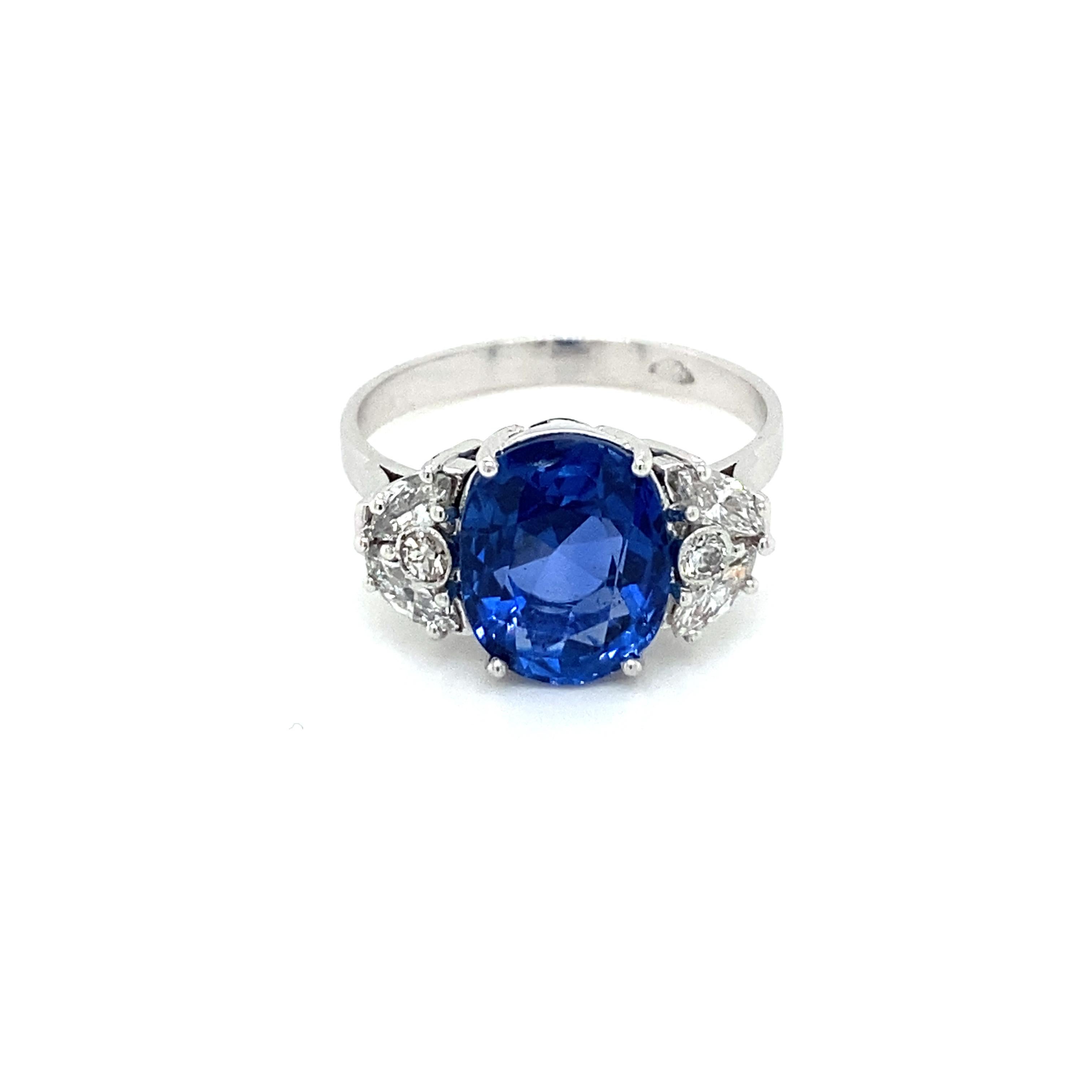 An exquisite ring handcrafted in Platinum, featuring an amazing rare vivid 4,40 carat Unheated untreated Natural Ceylon Sapphire oval-shape, surrounded by 0,50 carats of round brilliant and marquise cut diamonds.

The Sapphire is accompanied by a