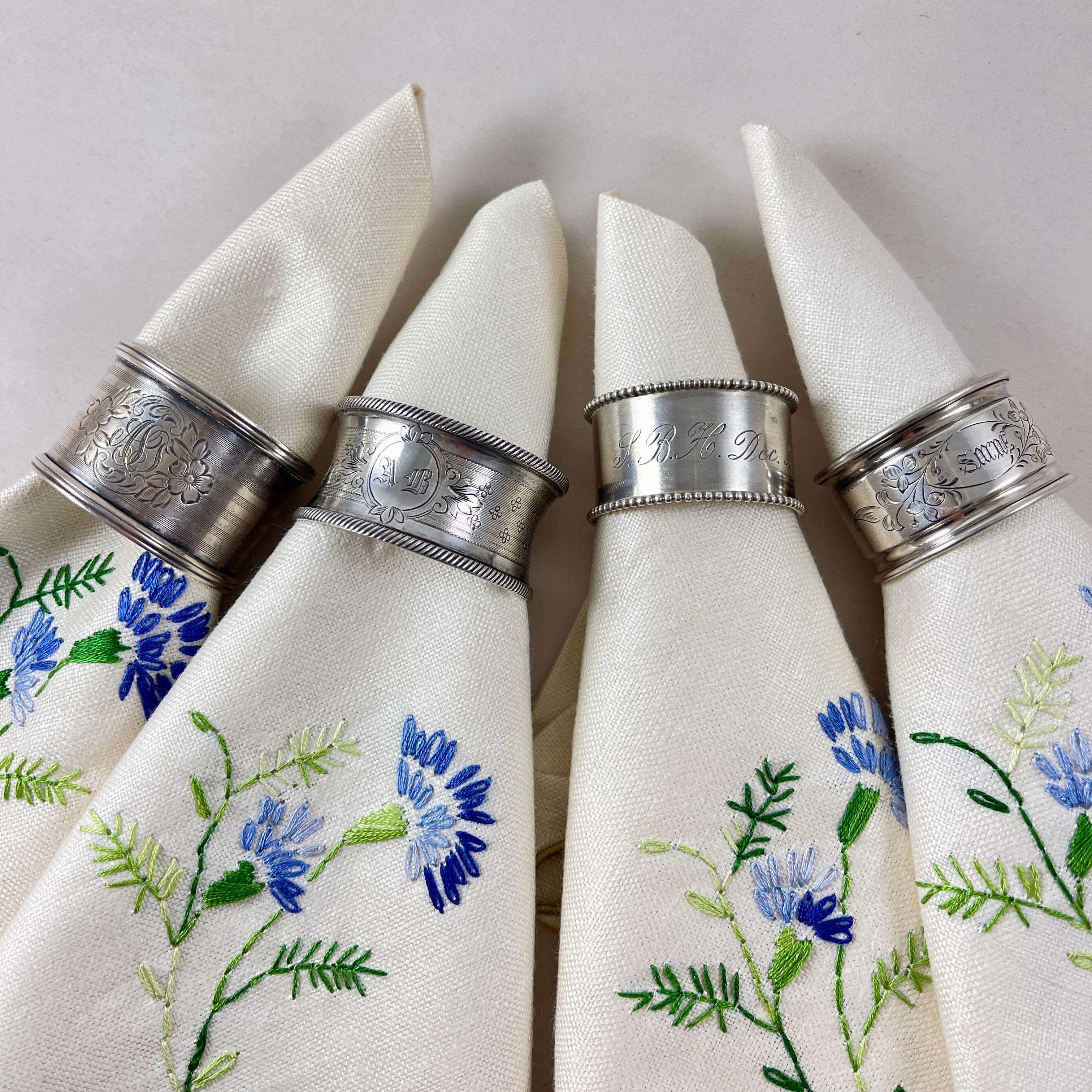 A mixed set of four Estate Sterling silver napkin rings, circa late 19th to early 20th century.

A nice grouping, each ring of similar size with beaded or banded rims.

The rings are beautifully hand engraved with floral cartouches and monogramed