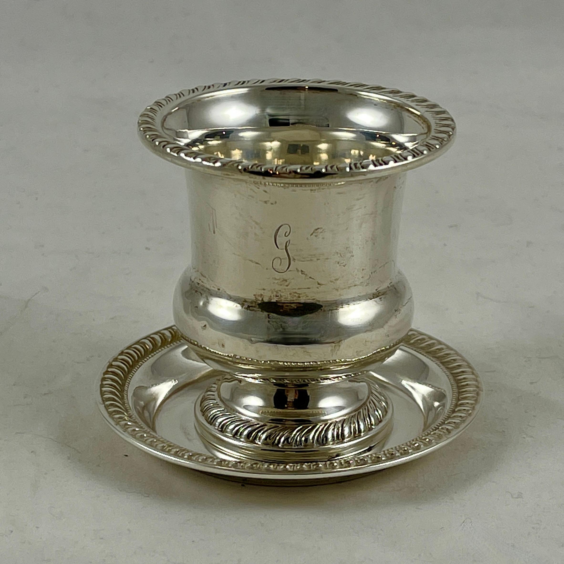 A two-piece sterling silver smoke set, Mueck-Carey Silver Co. New York, New York, circa 1940-1950s.

Suitable as a match holder with a spent tray, finished with gadroon edging. Both pieces show a faintly engraved initial ‘G.’

1.616 Troy ounces