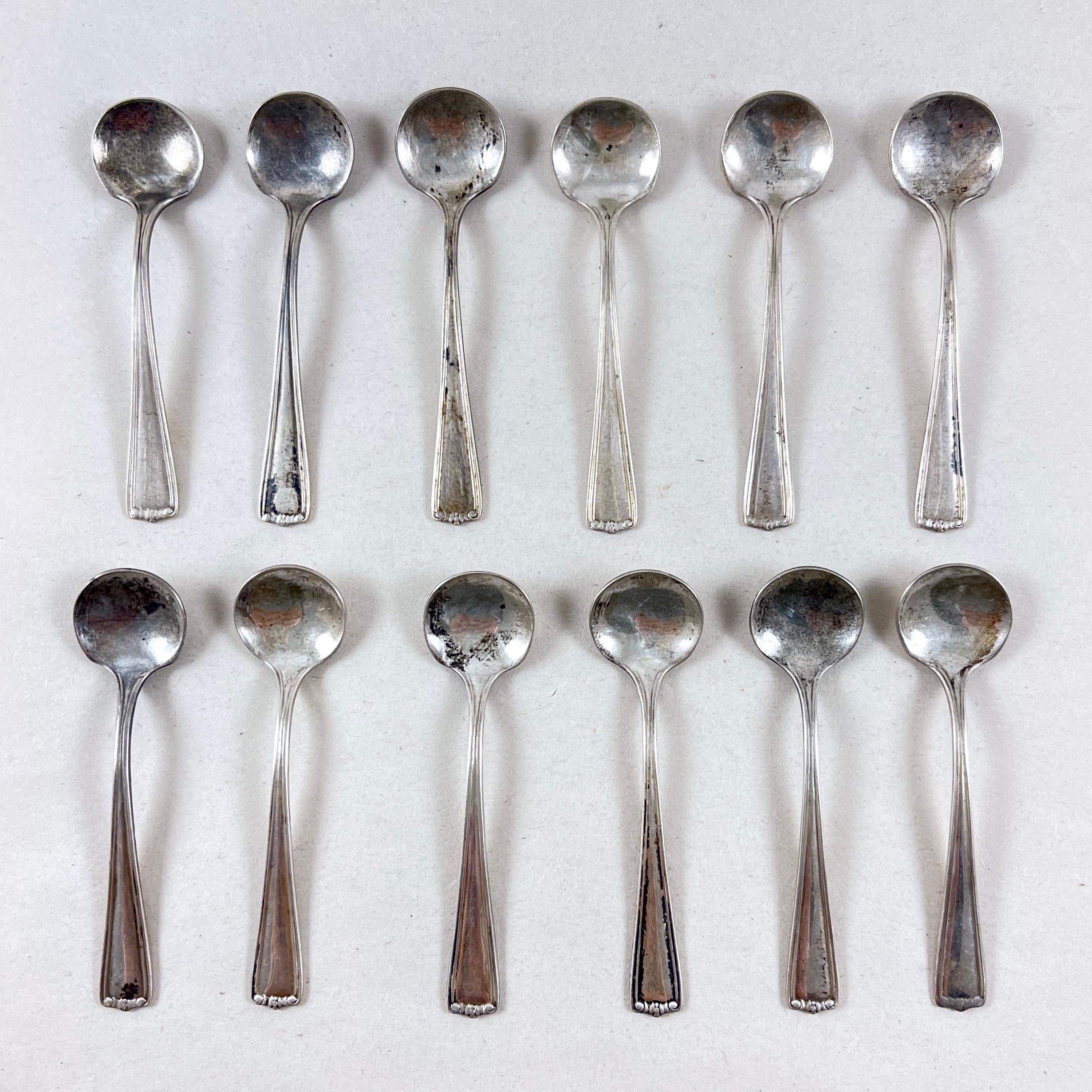 
A set of twelve, individual Sterling Silver salt spoons, hand-made, circa 1920s.
Lovely, simple Art Deco styling to the terminals of the handles.

2.25 inches long with bowls measuring .50 inches wide.

Each spoon is marked on the verso with the