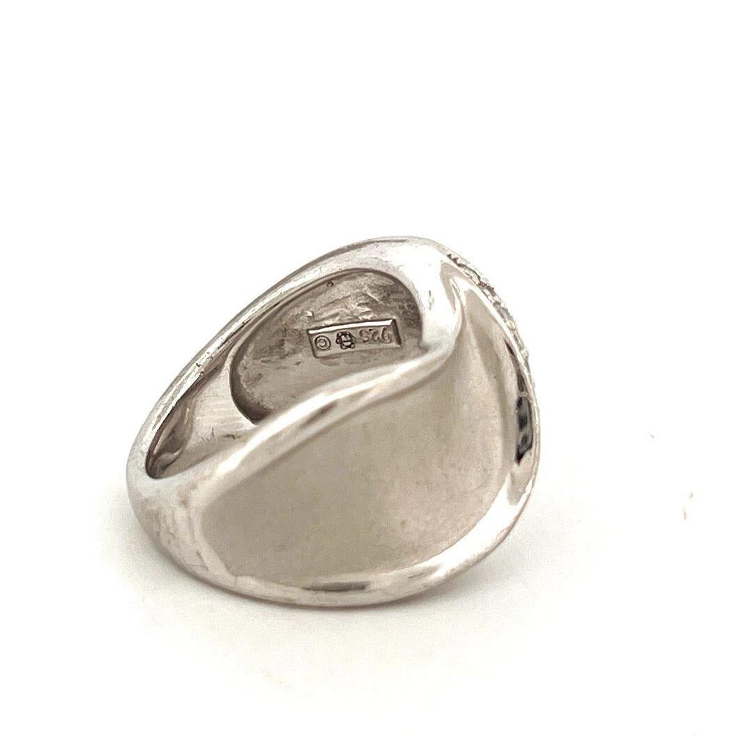 Offered here is a stylish sterling silver diamond wave band ring featuring a modern brushed and polished finish. Crafted in solid 925 sterling silver, the ring is stamped 