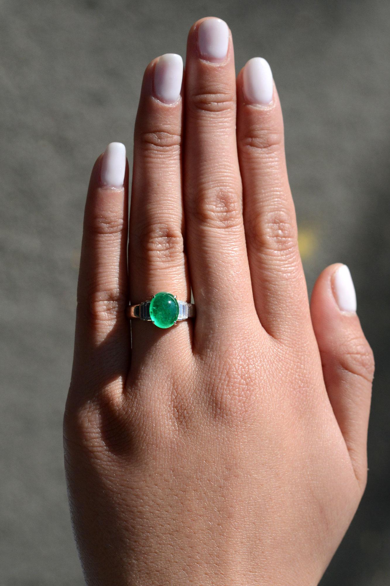 This classic Art Deco era gemstone engagement ring centers on a gorgeous 3 carat Colombian emerald cabochon with an intense, vivid green full of life. The term 