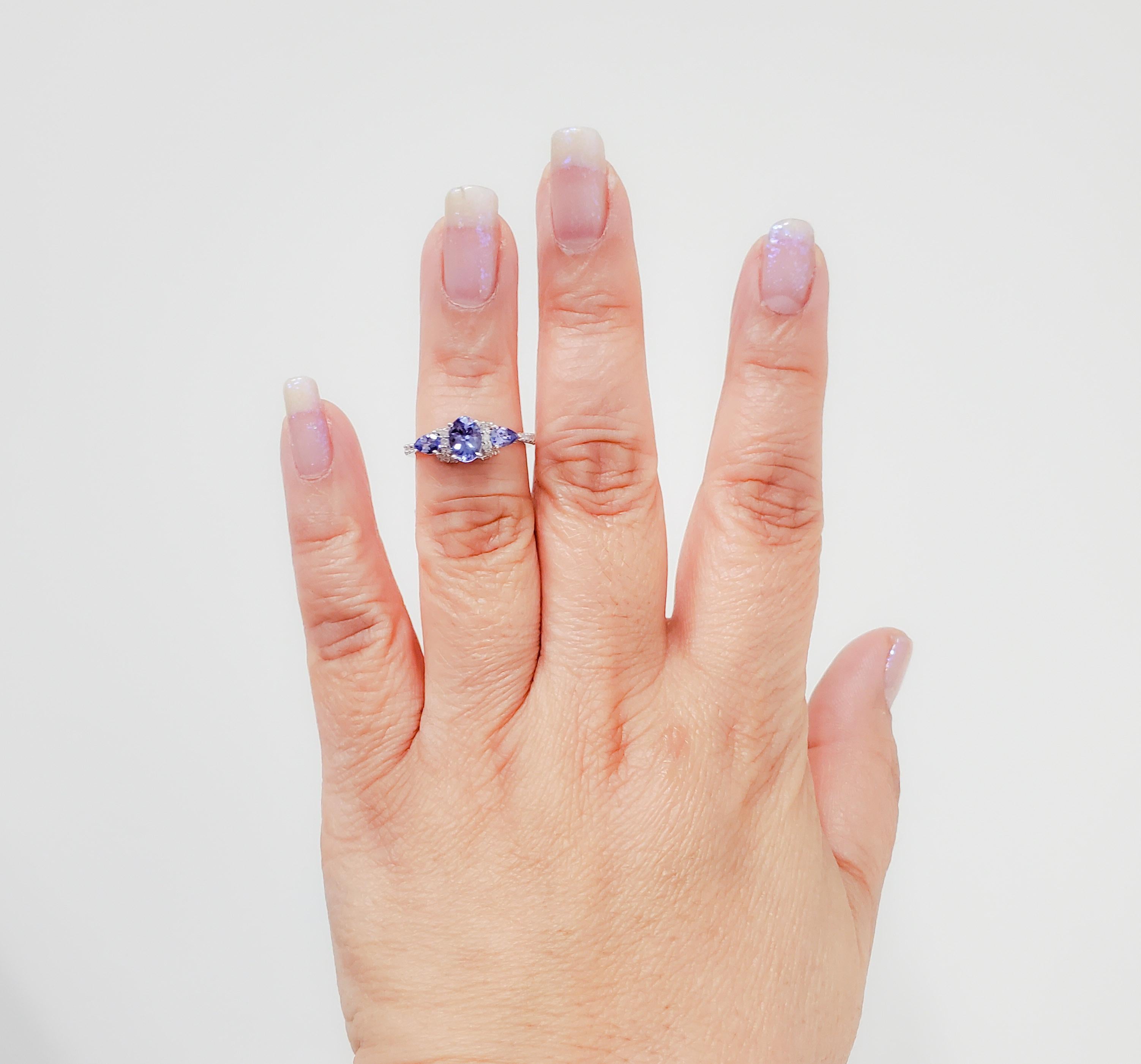 Beautiful 3 stone ring with 1.11 ct. of tanzanite oval and pear shapes and 0.23 ct. of good quality white diamond rounds.  Handmade in 14k white gold.  Ring size 7.25.