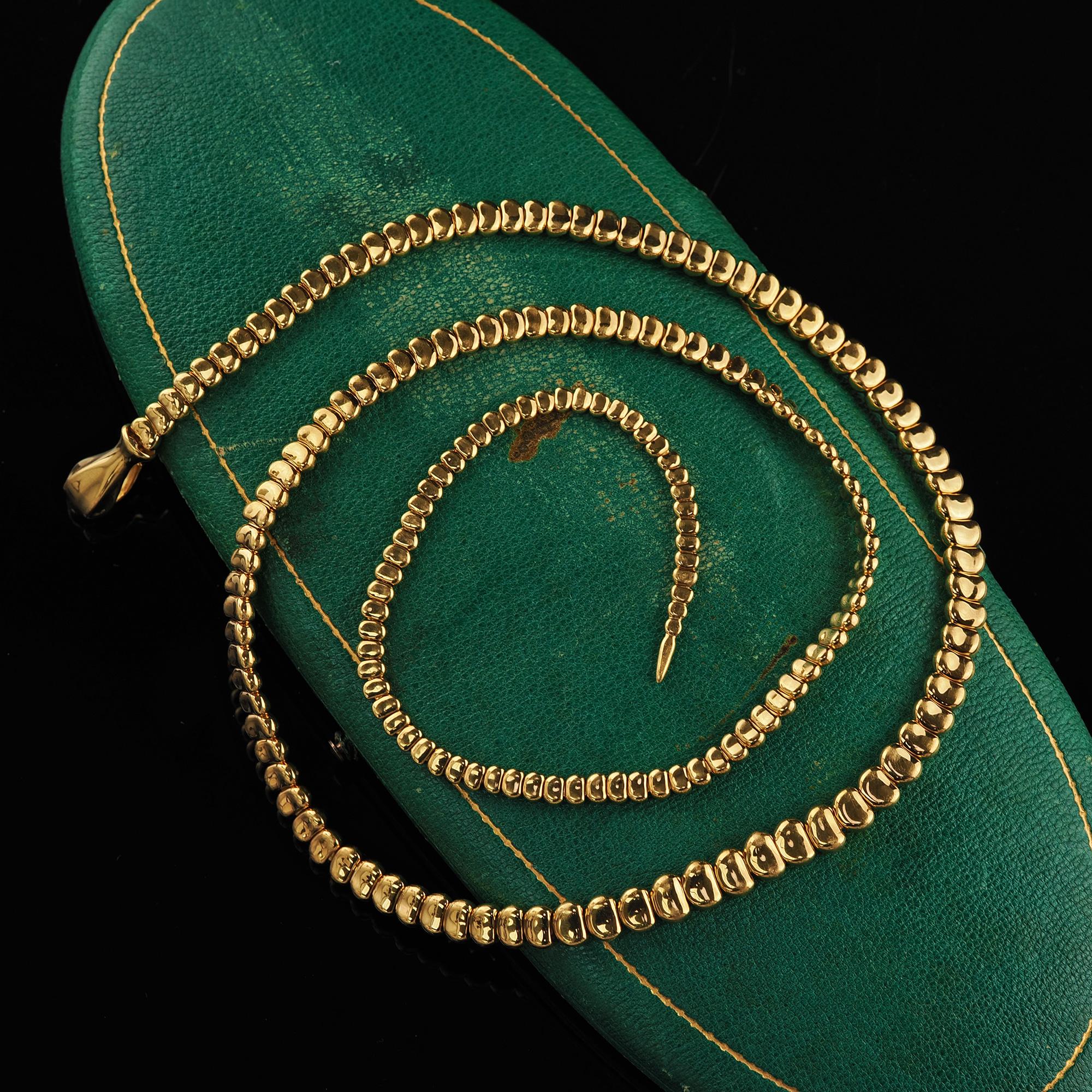 Beautiful Estate Tiffany and Co Elsa Peretti 18K Yellow Gold Snake Necklace - 27.5 inches. This incredible Tiffany and Co Elsa Peretti snake necklace is crafted in 18k yellow gold. This gorgeous necklace is the original version of the current
