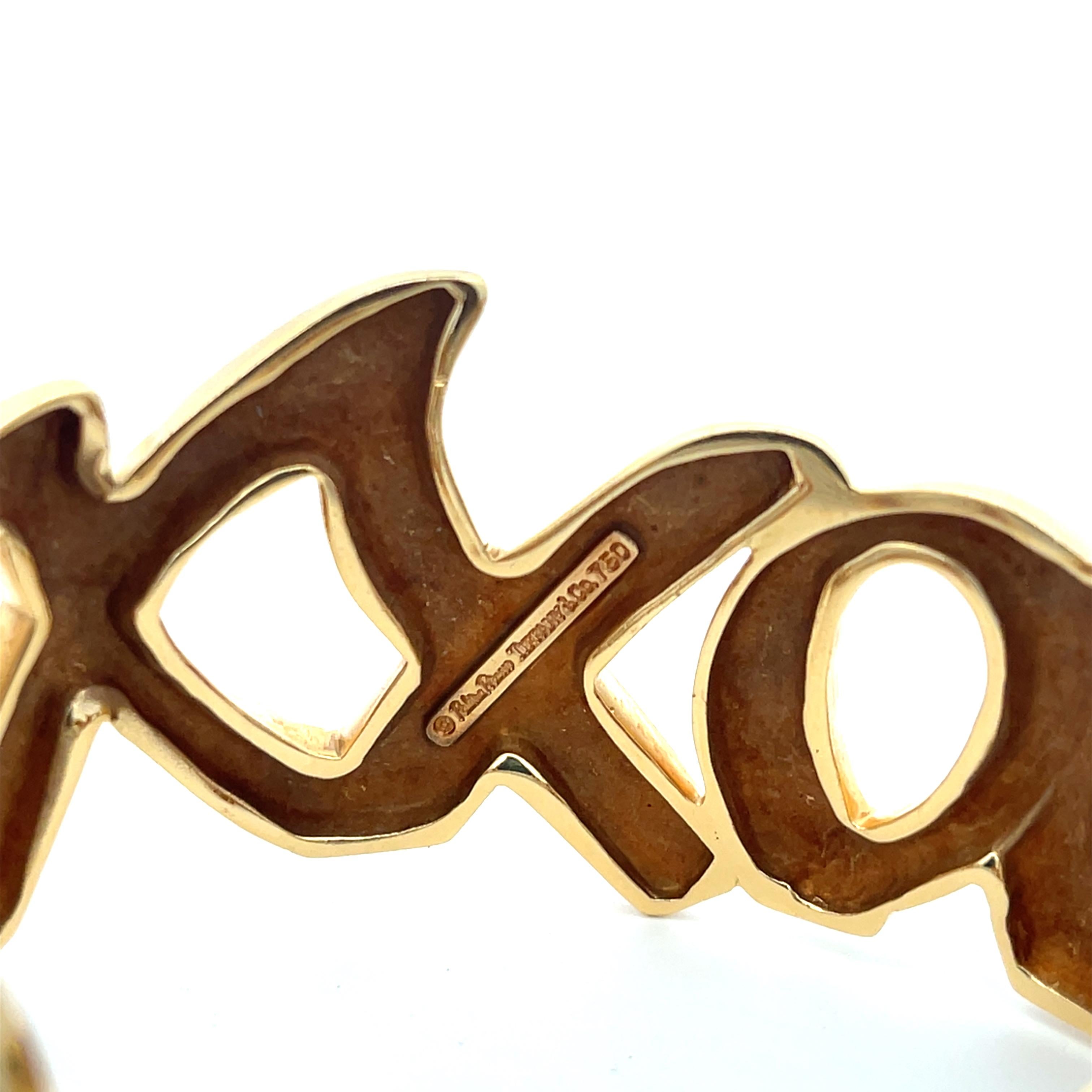 Estate Tiffany & Co. by Paloma Picasso Love and Kisses Cuff in 18K Yellow Gold. Vintage cuff circa 1984. Weighs 80 grams and is 1.25
