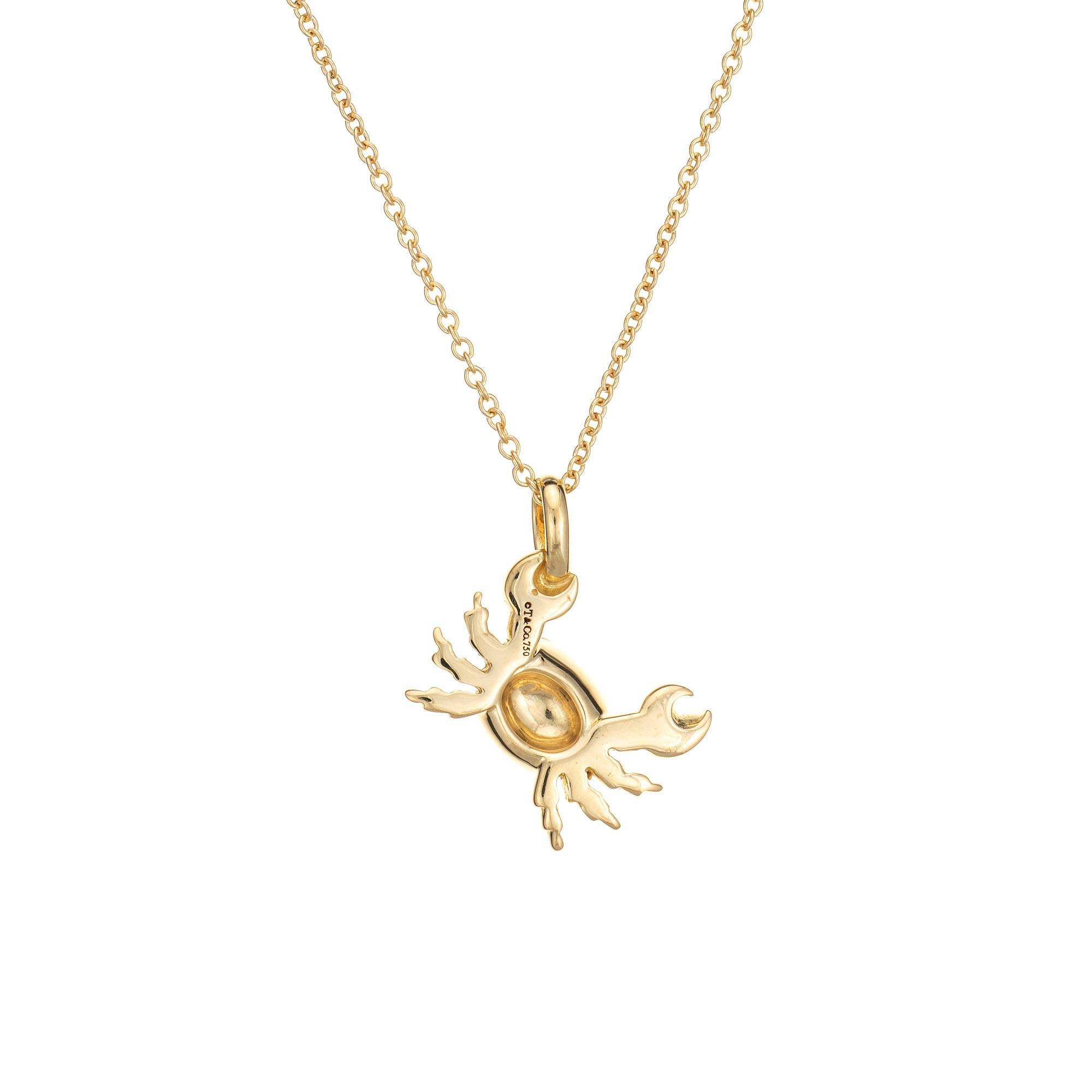 Stylish pre-owned Tiffany & Co heart crab necklace crafted in 18 karat yellow gold.  

The crab is set with two small diamonds to the eyes (0.01 carats estimated - G-H color and VS2 clarity). The crab is small in scale and comes with a Tiffany & Co