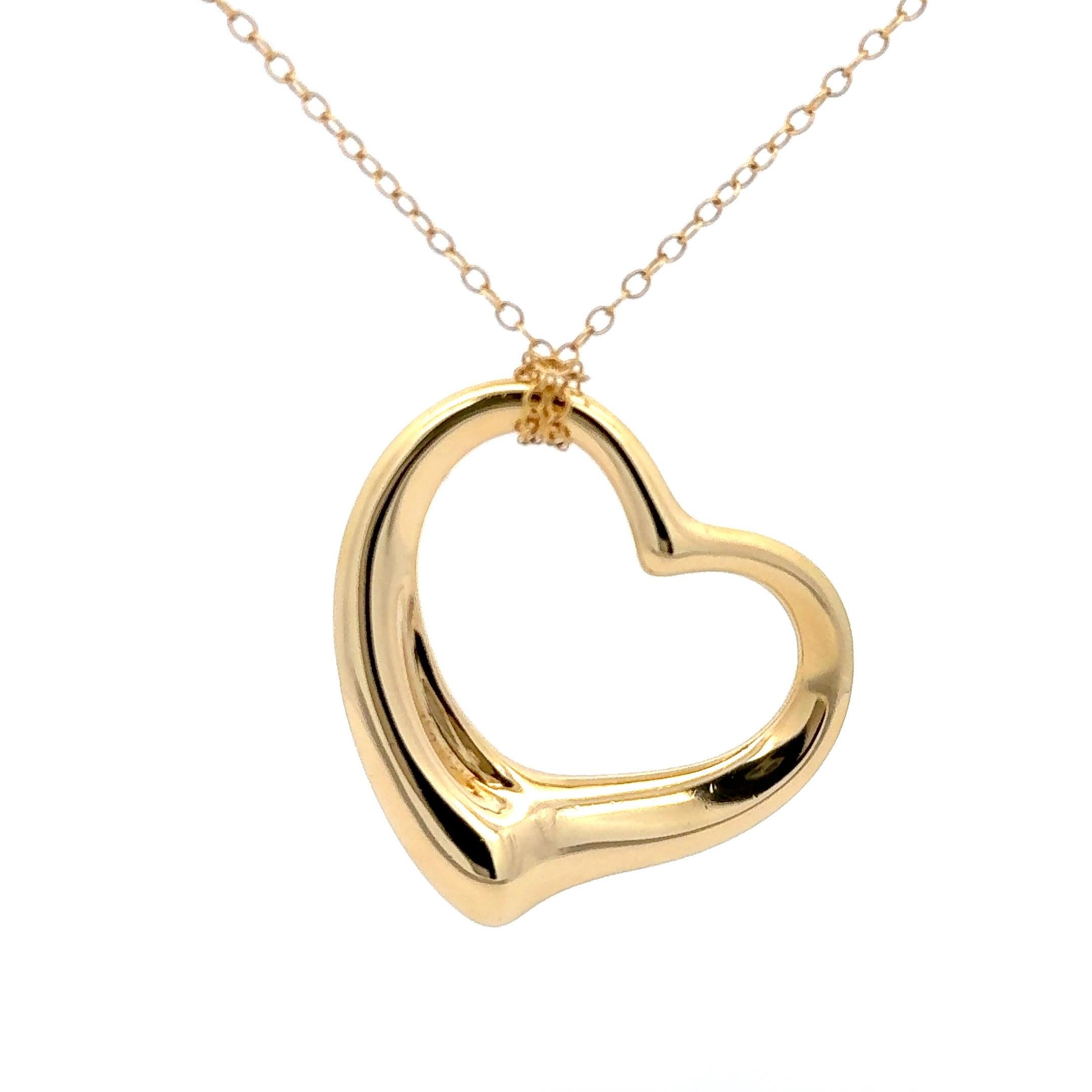 Tiffany & Co. Elsa Peretti 36mm Open Heart Pendant Necklace in 18K Yellow Gold. The pendant is on a 30 inch chain. Total weight is 14 grams. 