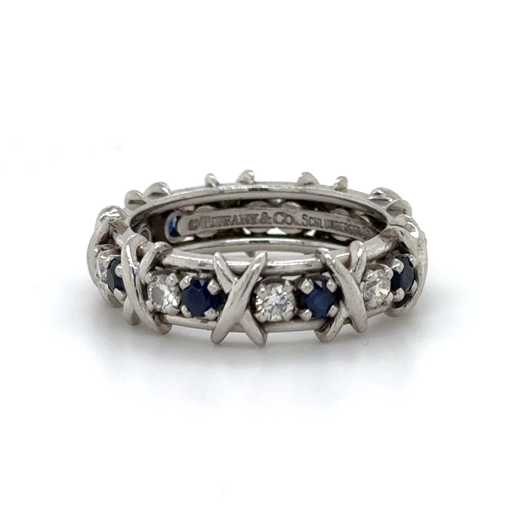 Estate Tiffany & Co. Schlumberger Studios collection ring.
9 round brilliant diamonds, 0.59 carats. Approximately F color and VS1 clarity. 9 round sapphires, 0.75 carats. Platinum, 11.6 grams, size 8.75.
Accommodated with an up-to-date digital