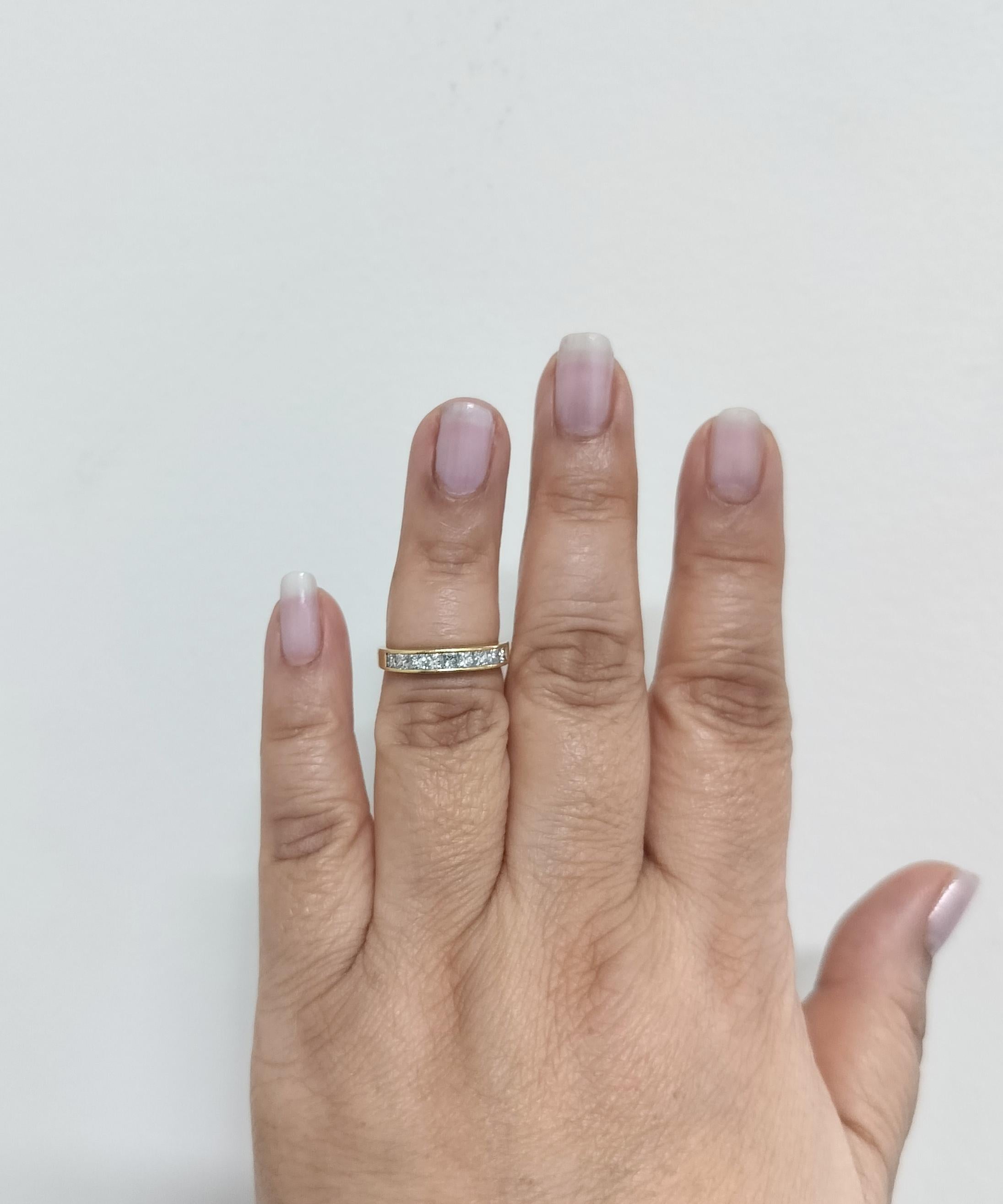 Beautiful estate Tiffany & Company 0.81 ct. white diamond princess cut band ring.  Handmade in 18k yellow gold.  Ring size 6.5.