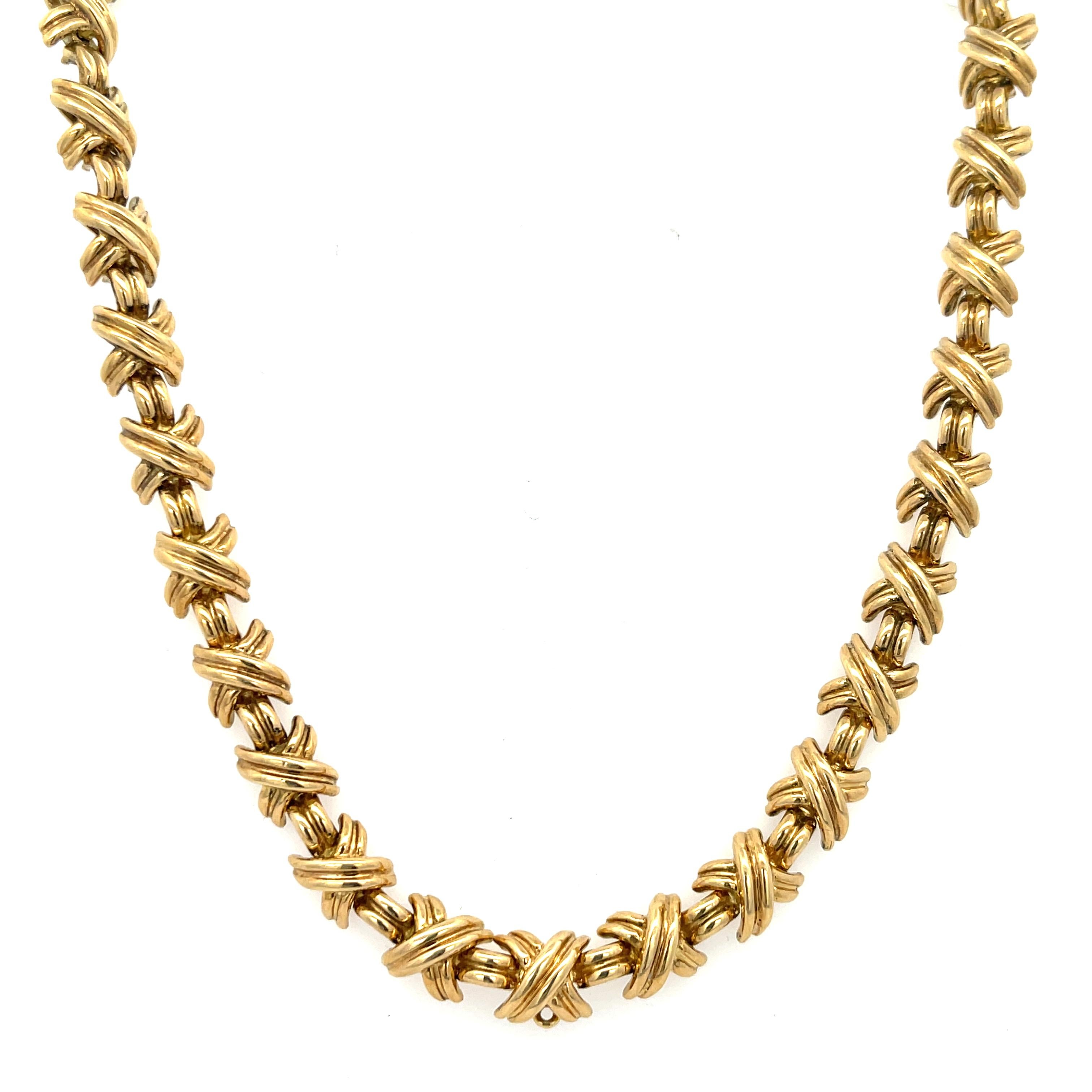 Estate Tiffany & Co. Small X Signature Collection Necklace in 18K Yellow Gold. The necklace is 16 5/8 inches long,  1/4 inches wide, and weighs 70.80 grams. The necklace features a hidden claps with safety latch. Singed T&CO 750.