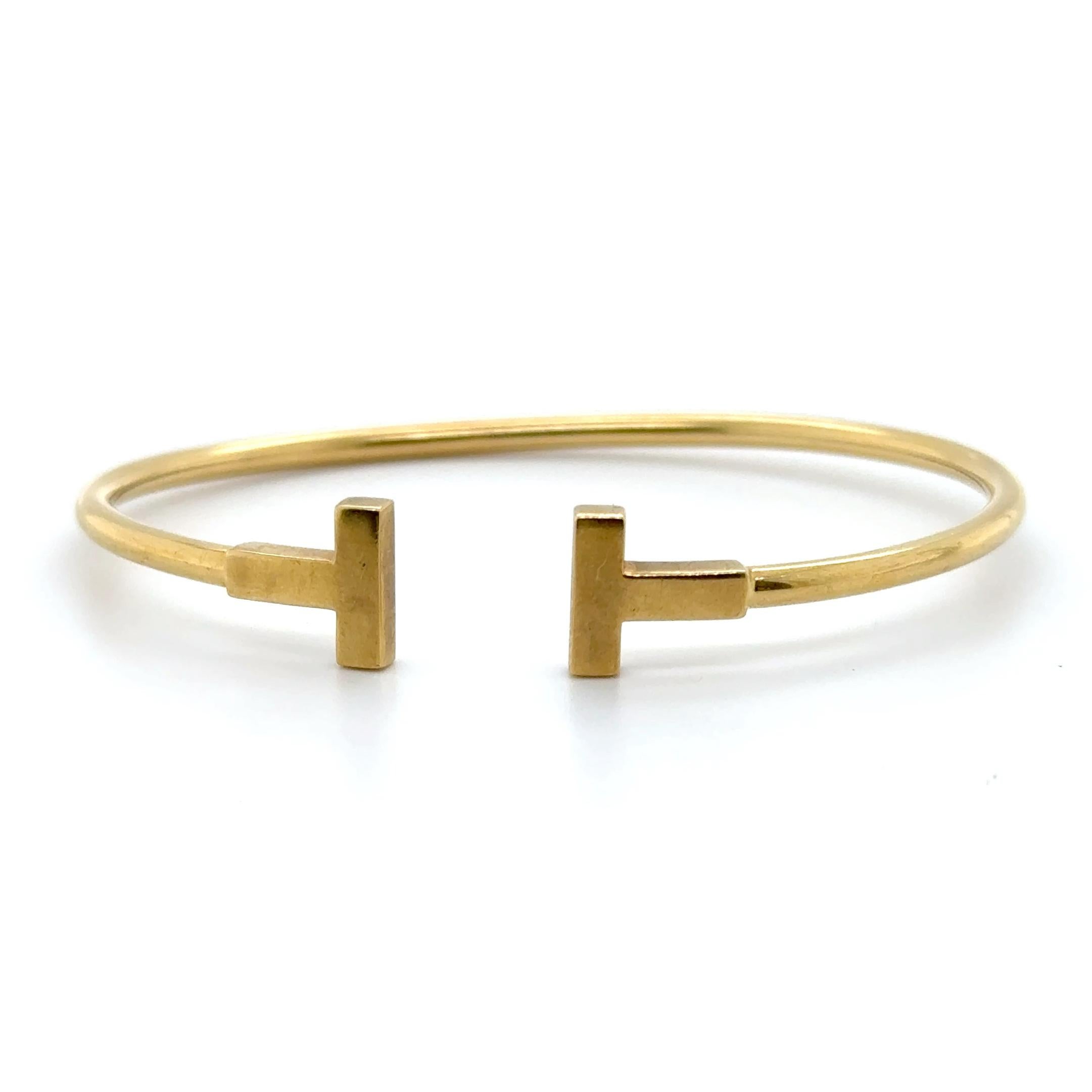 Original Tiffany & Co. T collection bracelet / bangle.
Made in Italy, 18k yellow gold, 7.9 grams, size 15.
Accommodated with an up-to-date digital appraisal by a GIA G.G. once purchased, upon request. Please contact us with any questions. Thank