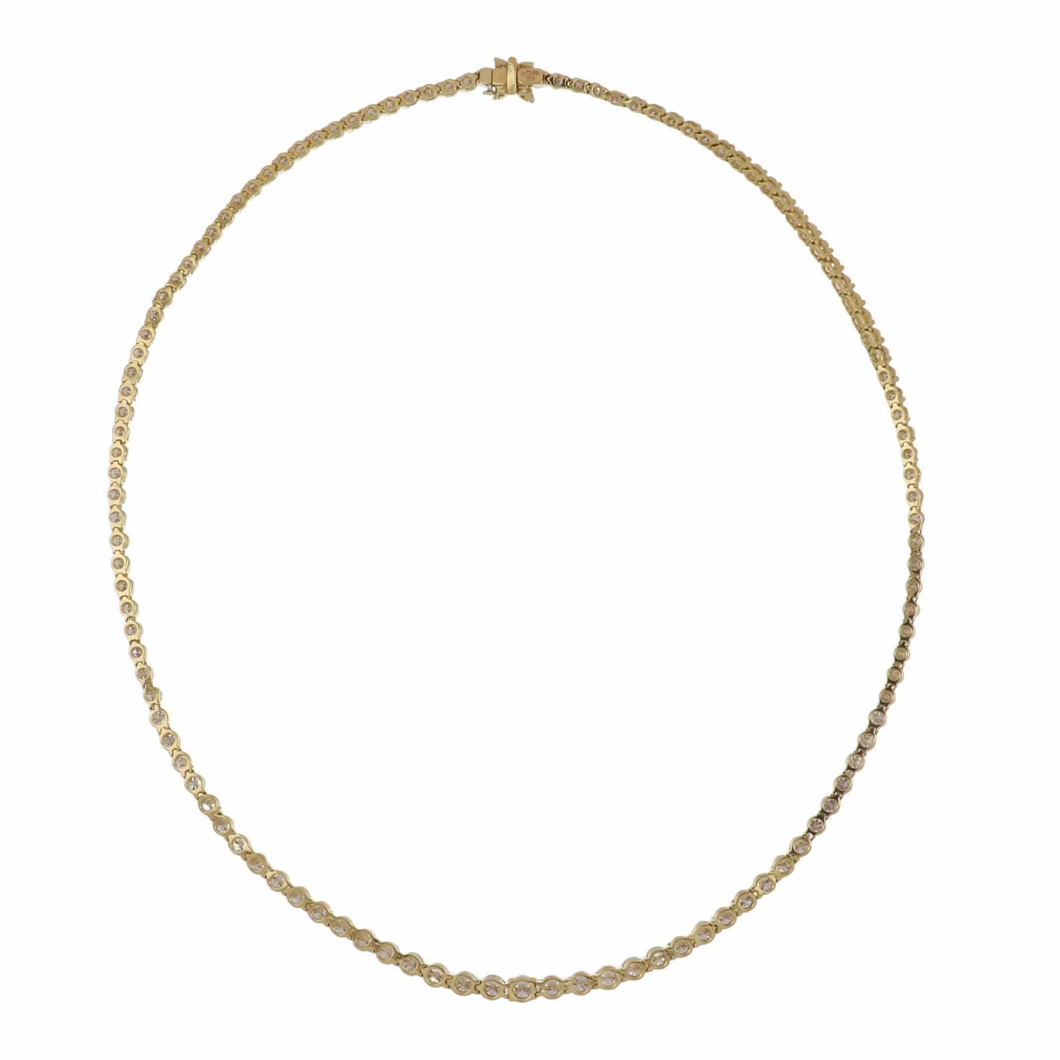 An estate Tiffany & Co. Victoria graduated round diamond riviera necklace in 18K yellow gold. There are 115 round brilliant-cut diamonds that total 10.18 carats and 4 marquise-shaped diamonds at the clasp that total 0.21 carats.  All diamonds are