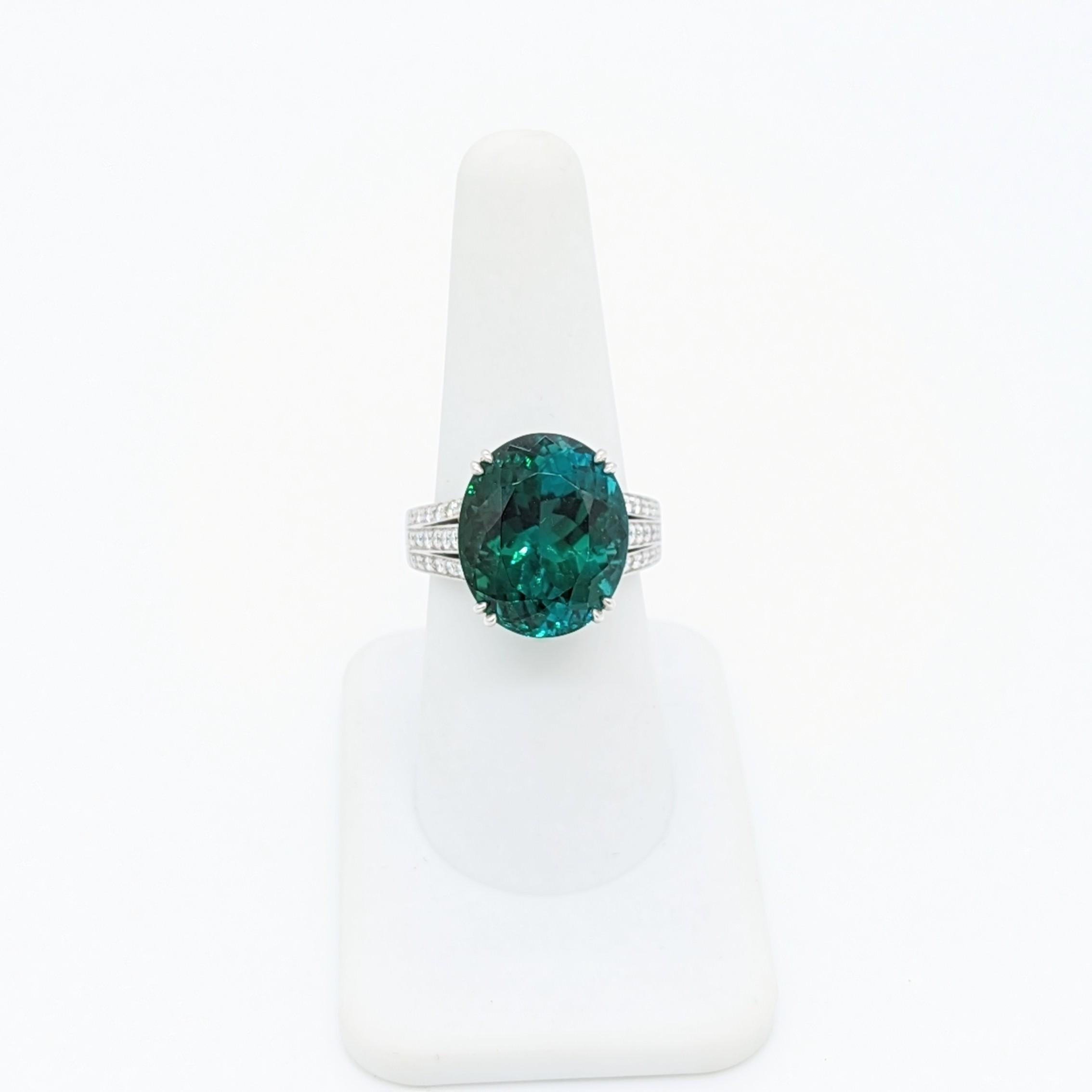 Stunning 8.80 ct. green tourmaline oval with 1.30 ct. good quality, white, and bright diamond rounds.  Handmade in platinum.  Ring size 6.75.  