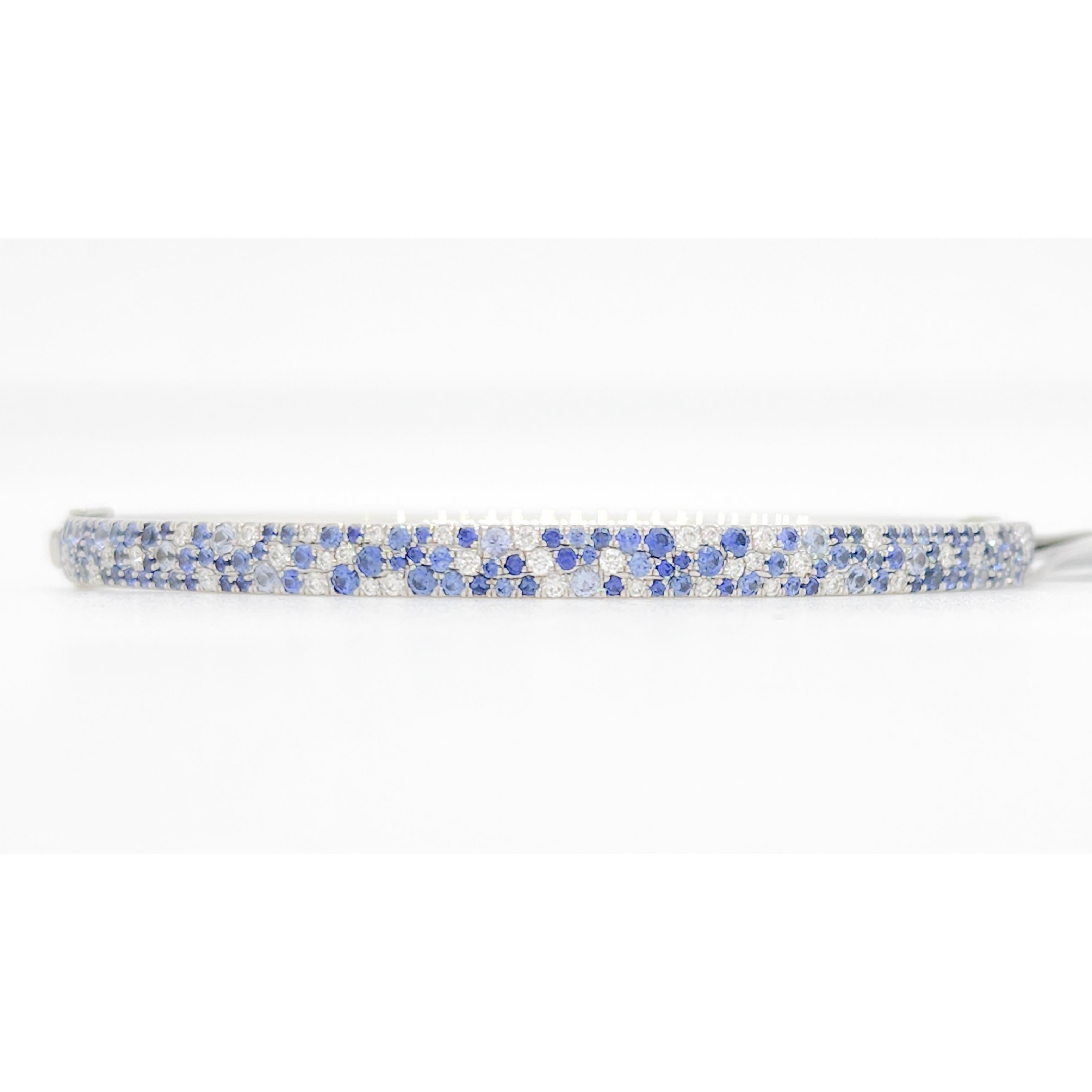 Gorgeous Tiffany & Company Metro bangle with 4.00 ct. good quality blue sapphire round and 1.00 ct. good quality white diamond rounds.  Handmade in 18k white gold.  