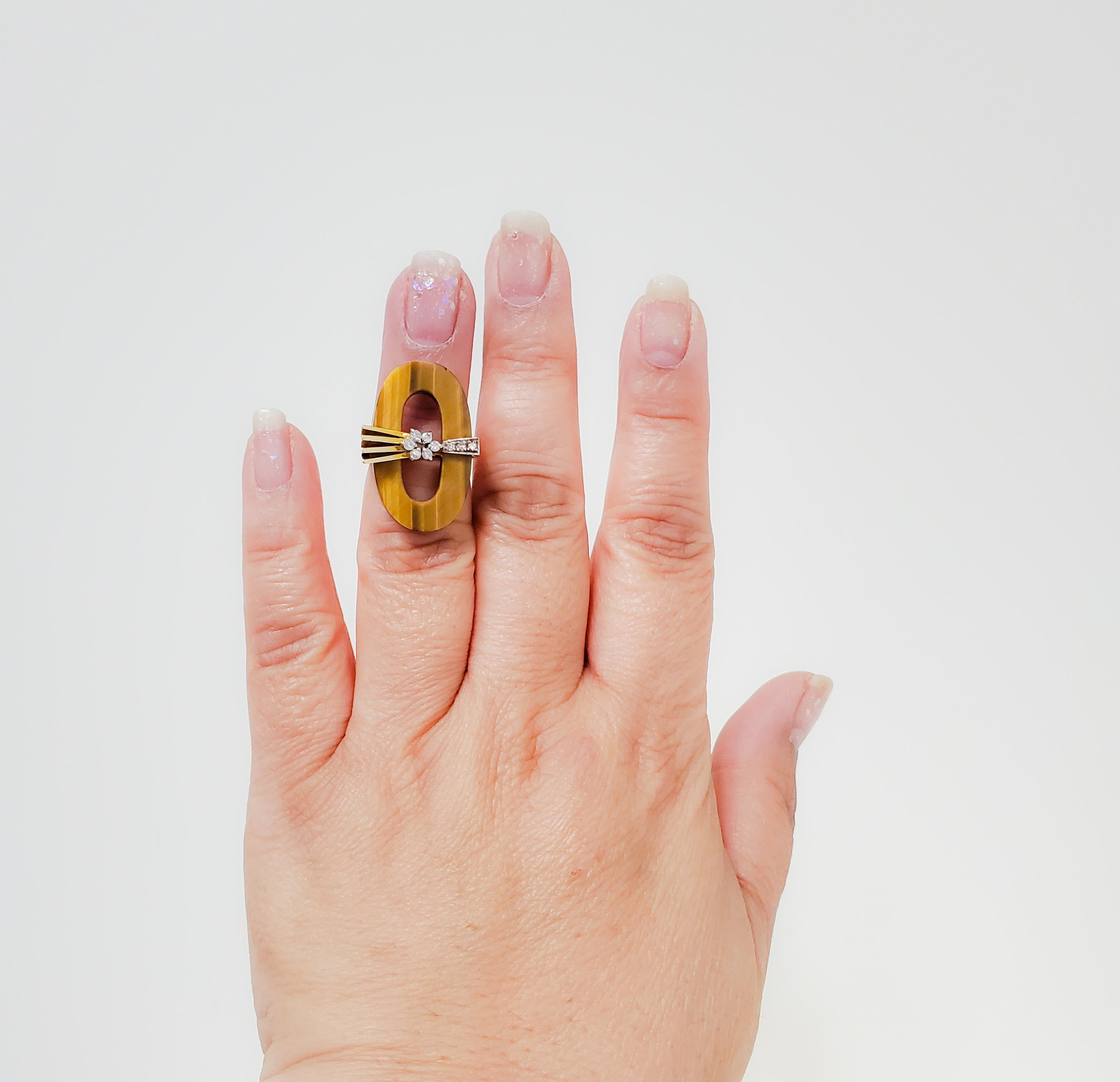 Beautiful ring with tiger eye and 0.05 ct. white diamond round.  Handmade in 14k yellow gold.  Ring size 4.5.