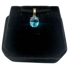 Pendentif/collier en or jaune 14 carats avec topaze bleue de 11 x 9 mm