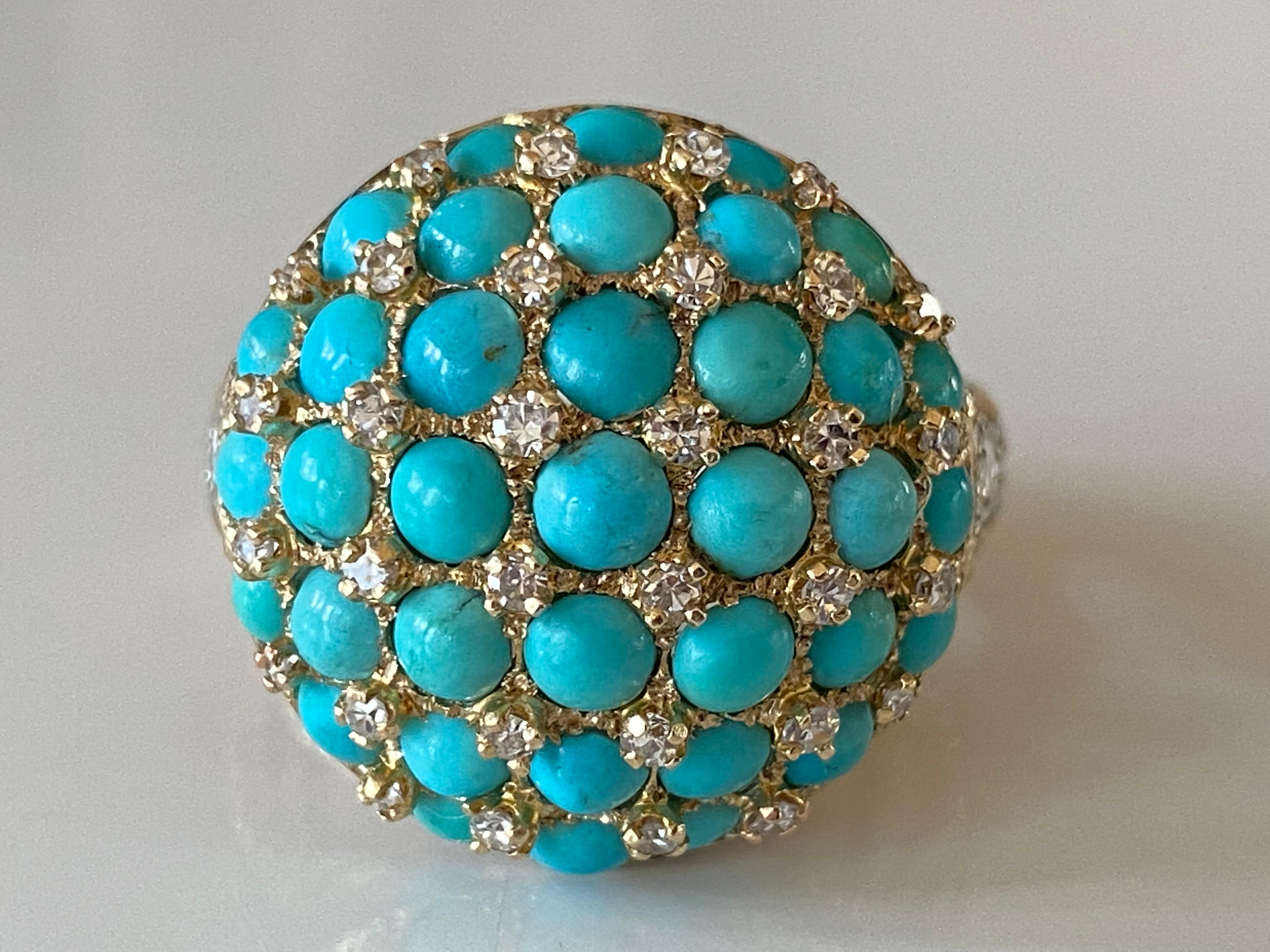 This magnificent Mid-century cocktail ring features thirty-seven round cabochon natural turquoise interspersed with thirty-two single cut diamonds arrayed over a dome shape with two marquise diamonds and six additional single cut diamonds tapered on