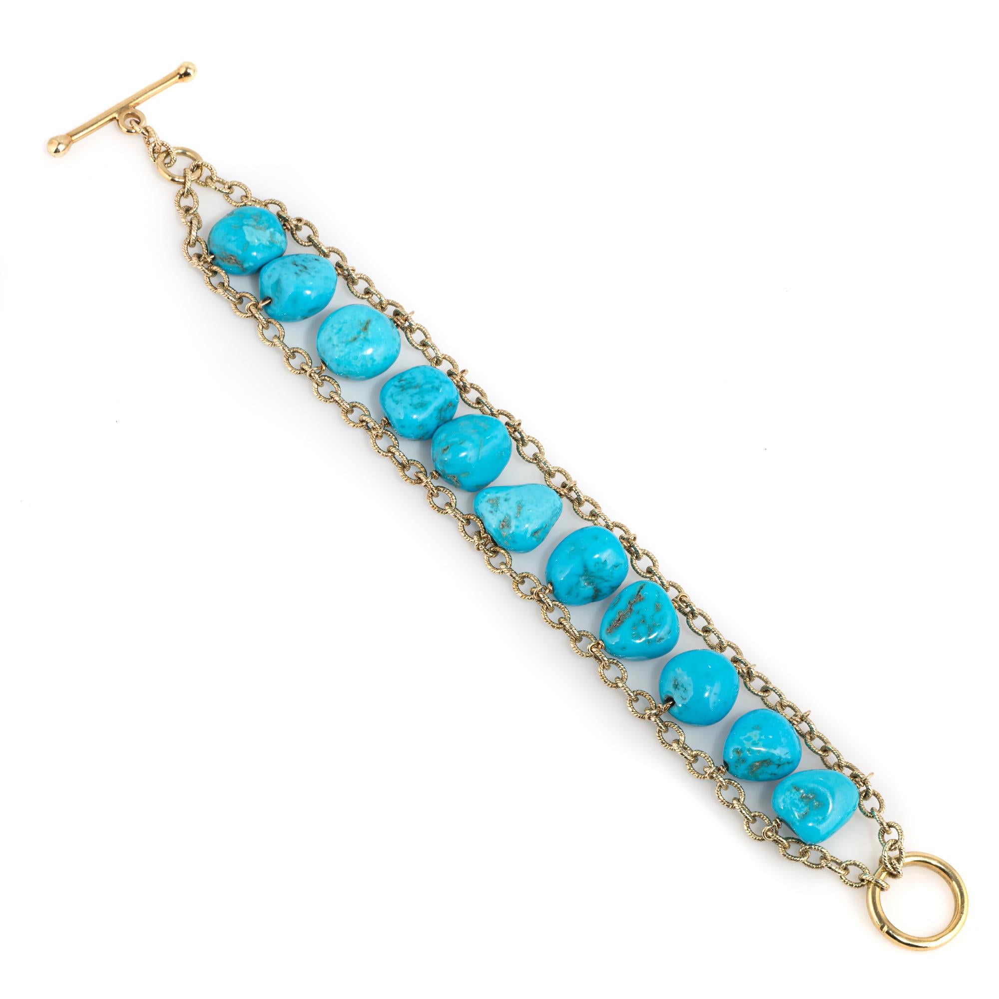 Stylish and finely detailed estate turquoise bracelet crafted in 14 karat yellow gold. 

Natural turquoise beads measure (average) 12mm each. The turquoise is in excellent condition and free of cracks or chips. 

The bracelet makes a nice statement