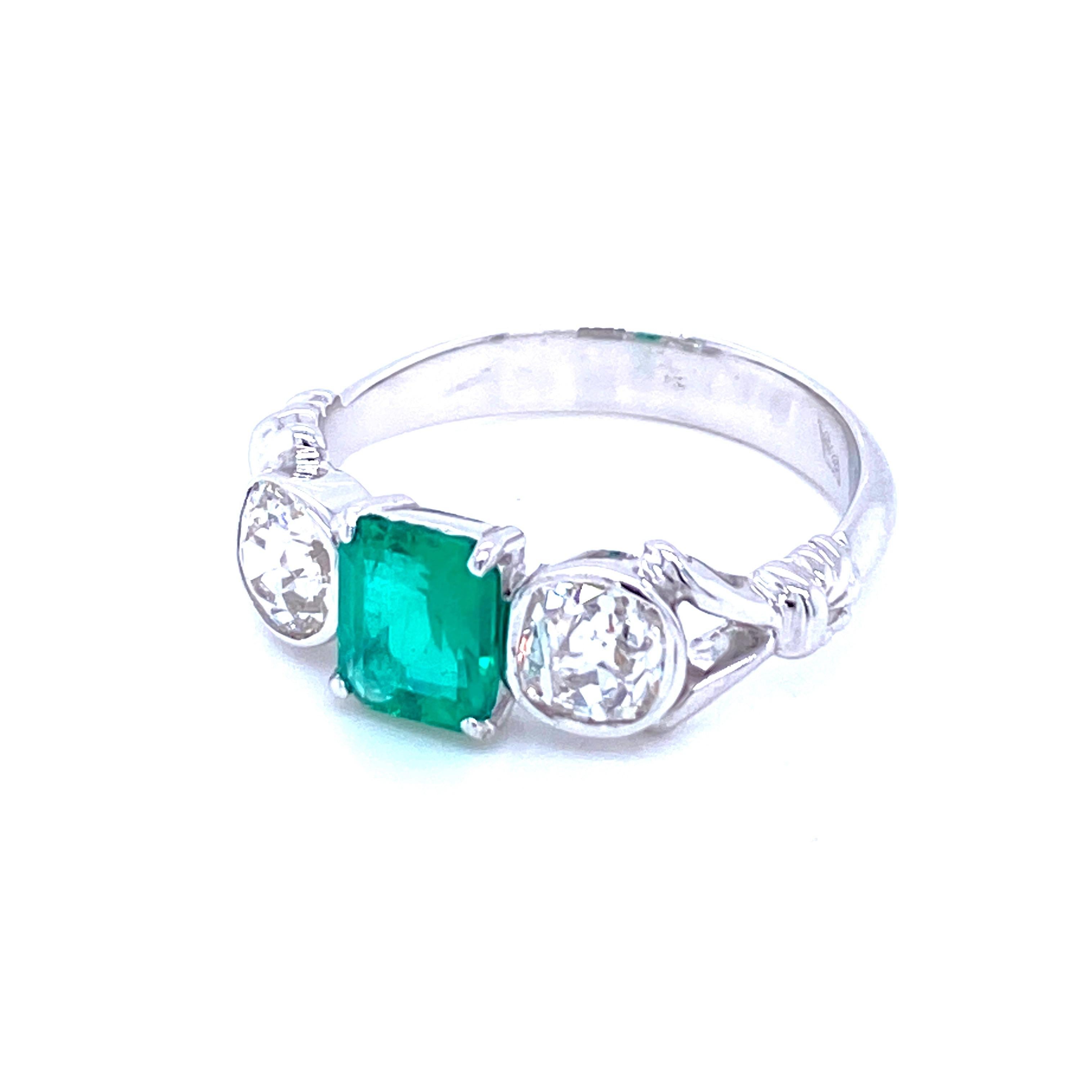 Classic three stone 18k Gold ring set with an Emerald cut  Colombian Emerald, free of any Oil/resin treatment, weighing 0.80 carats and 2 old cut diamonds with a total weight of approx. 0.80 carats I color Vs clarity. 

CONDITION: Pre-Owned -