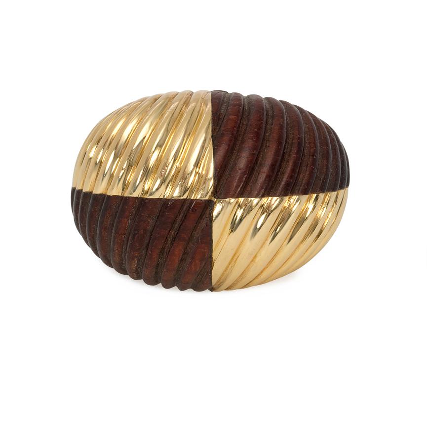 A gold and carved wood ring in the bombé style designed as four alternating ribbed segments in a checkered pattern, in 18k. Van Cleef & Arpels, France #5V580-6

Current ring size: US 5 1/2 (Please contact us with any re-sizing