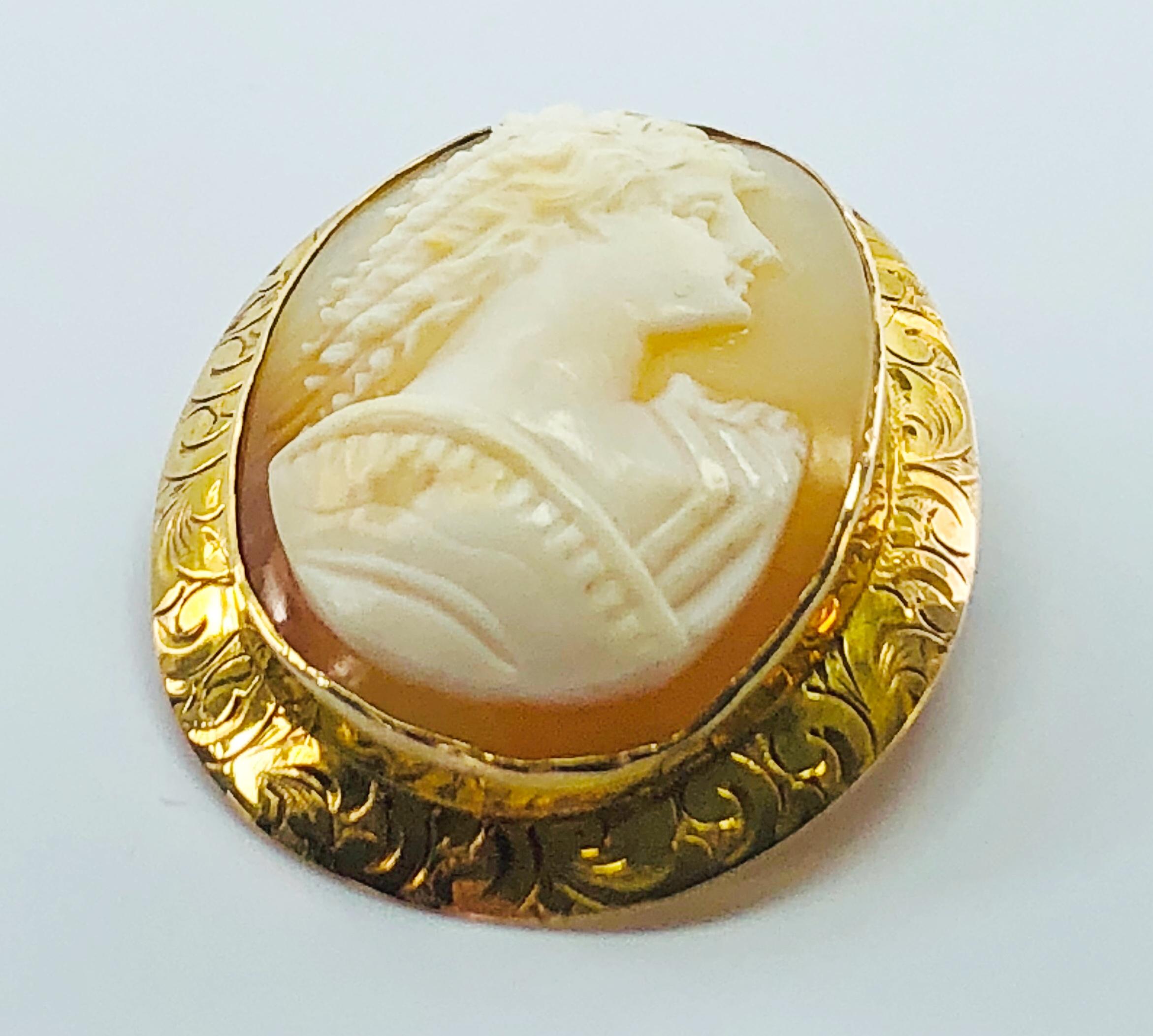 This is a Rare, Victorian, hand carved, Estate Cameo. Hand Carved Conch Shell, Gorgeous Profile of a Woman with Long, Beautiful Curls in her hair! The 10 K yellow Gold Bezel is beautifully engraved! One could easily add a Bale to this brooch so it