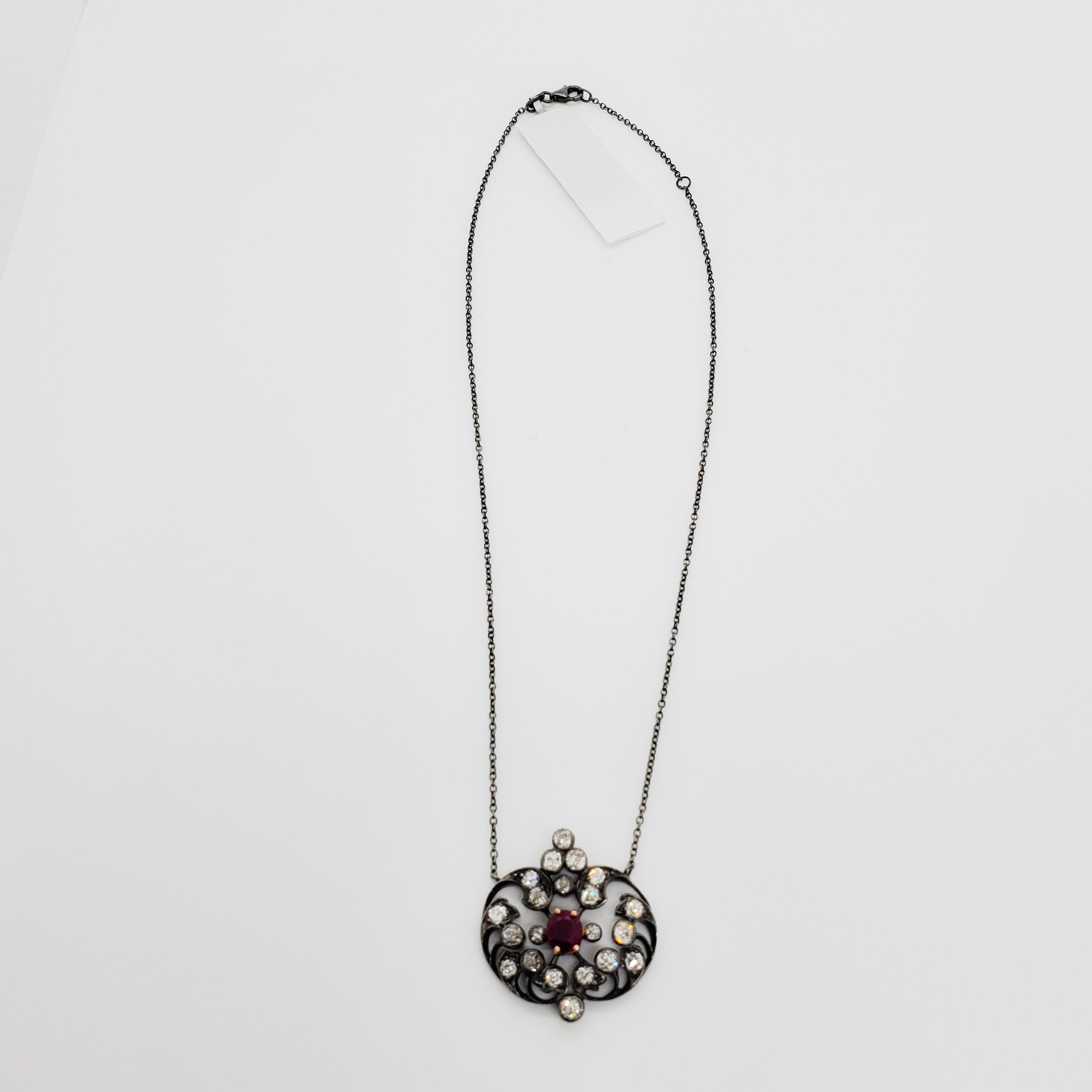 Gorgeous Victorian era necklace featuring a 1.59 ct. Burma ruby oval and 2.00 ct. of good quality white diamond rounds.  Handmade in 18k yellow and white black rhodium gold.