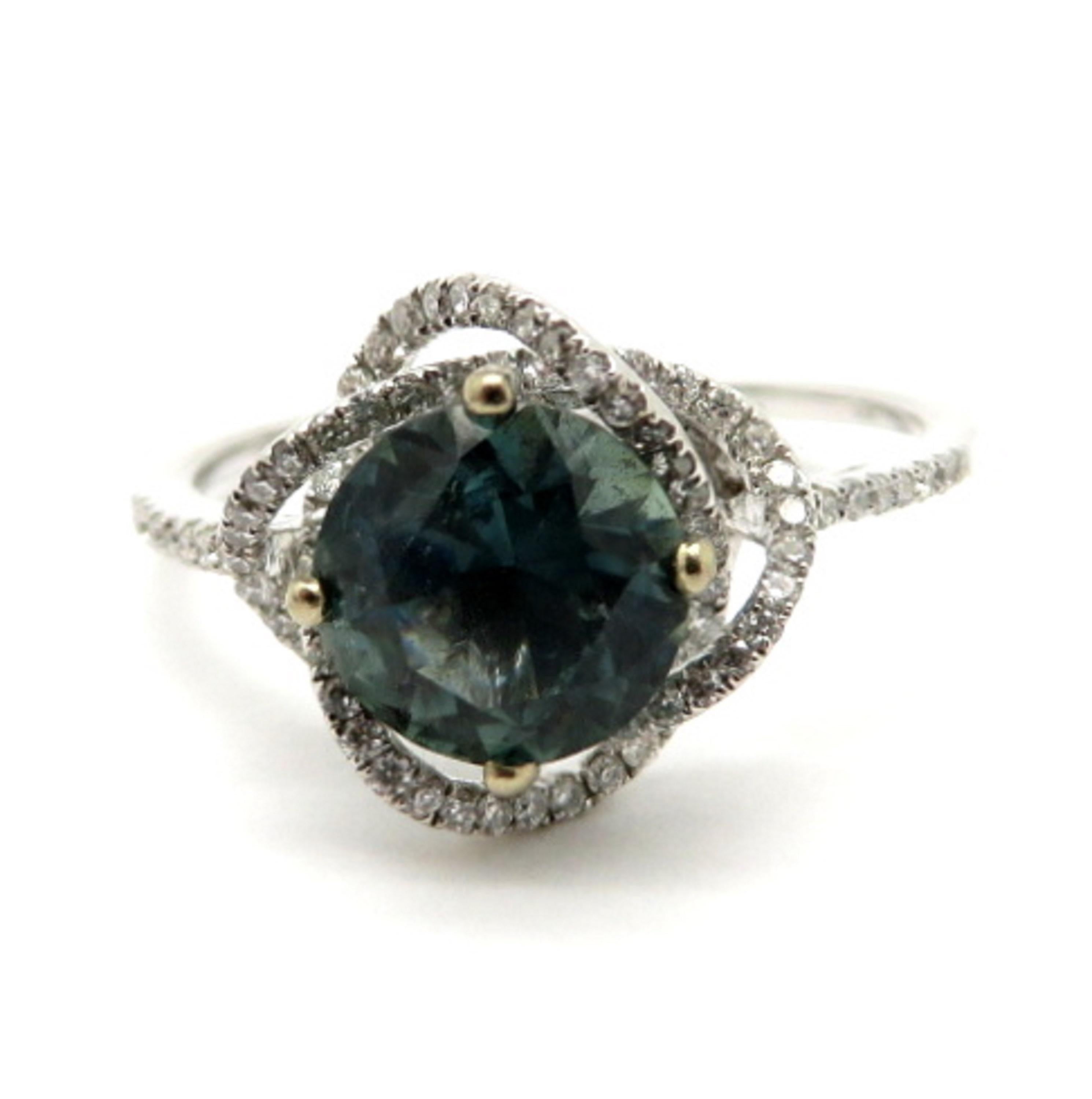 For sale is an 18K White Gold Sapphire and Diamond Ring in a floral setting!
Showcasing 1 Round Brilliant Cut fine quality bluish Green sapphire, weighing 1.51 carats.
Interspersed through the floral setting are 84 Round Brilliant Cut diamonds,